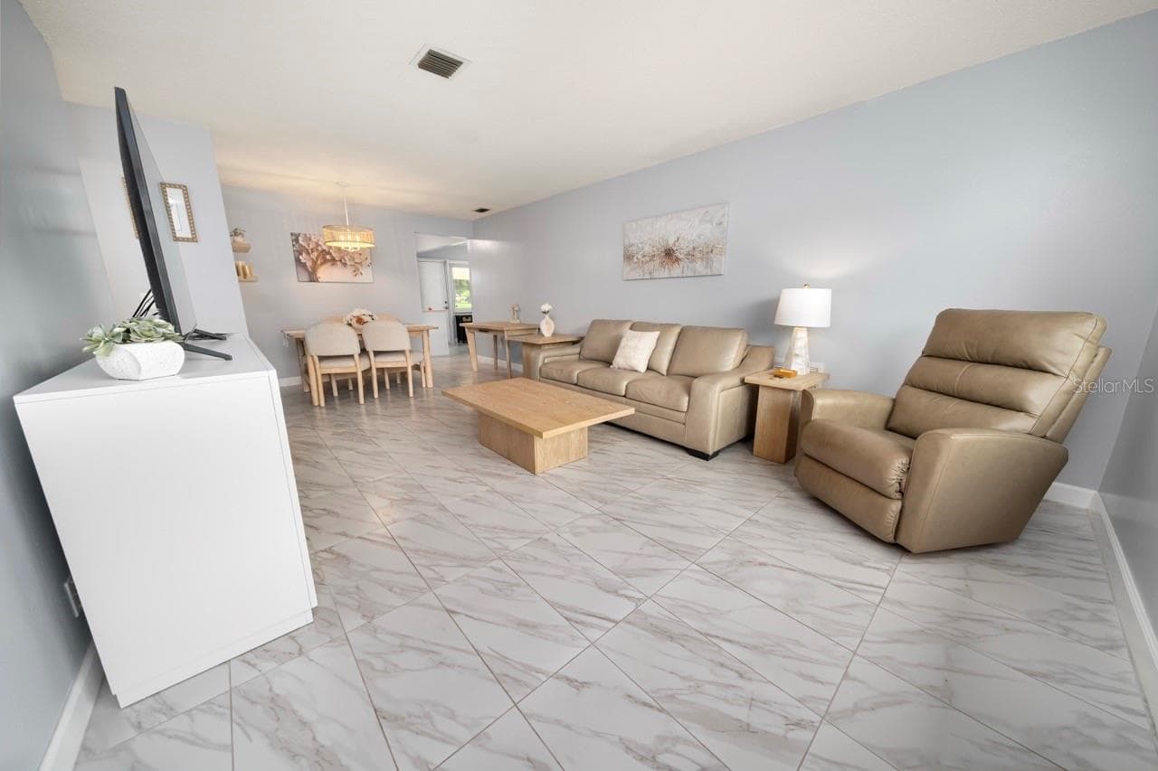 FAMILY ROOM. THIS VILLA STYLE CONDO IS PERFECT FOR ENTERTAINING FAMILY AND FRIENDS - 8235 BURGUNDY DR N #3, PINELLAS PARK