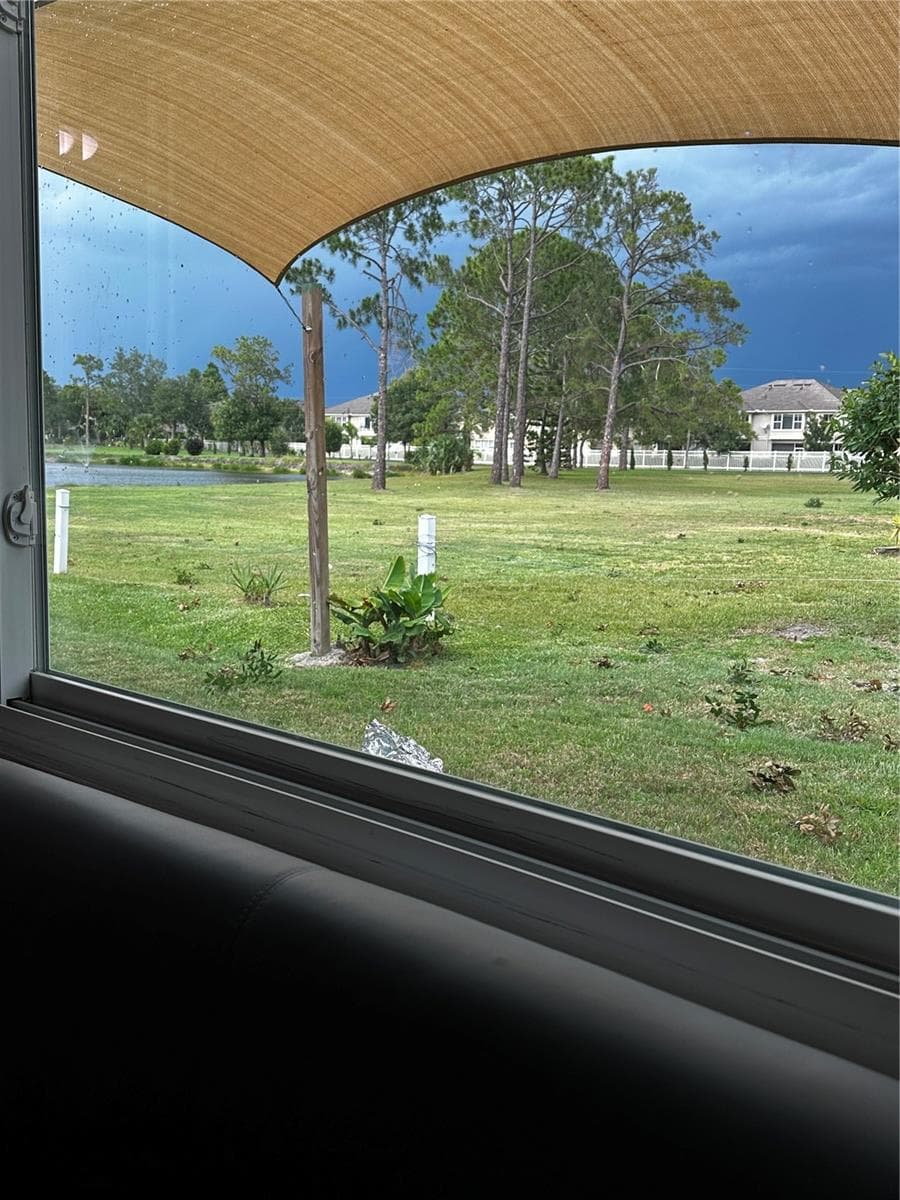 VIEW THROUGH THE LARGE WINDOW FROM YOUR LARGE KITCHEN BREAKFAST NOOK. - 8235 BURGUNDY DR N #3, PINELLAS PARK