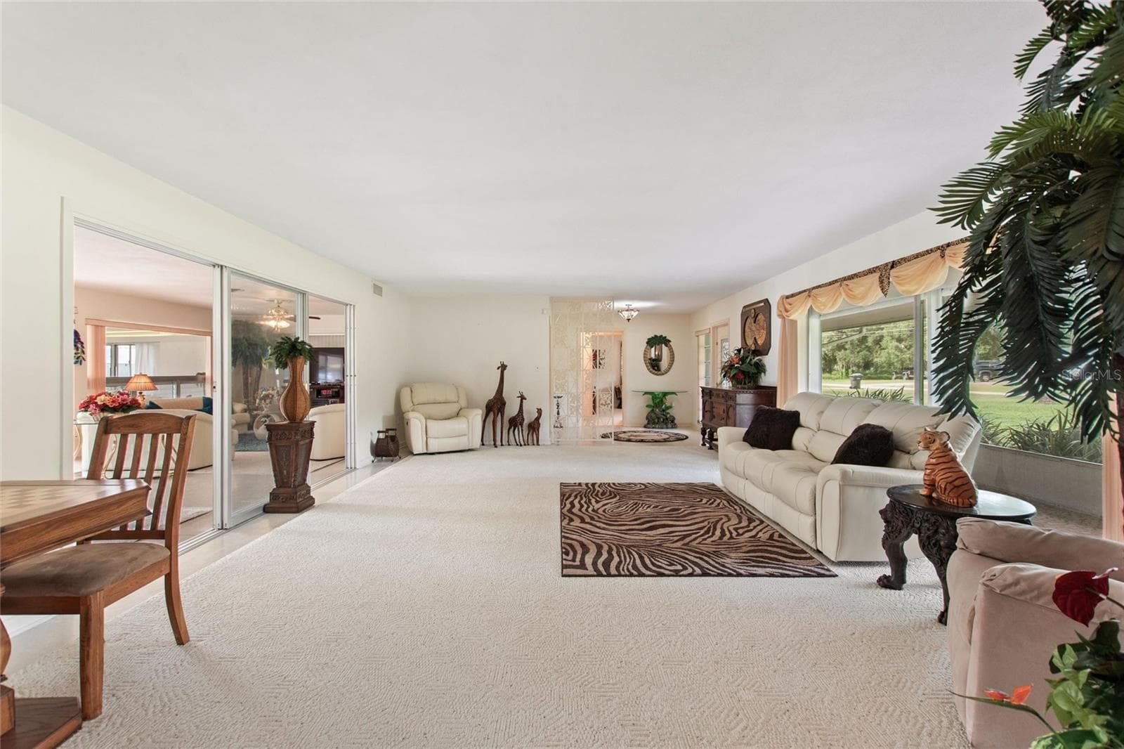 View looking back from the dining area to the living room, foyer. To the left are the informal living areas. - 6197 AMARYLLIS DR, INDIAN LAKE ESTATES