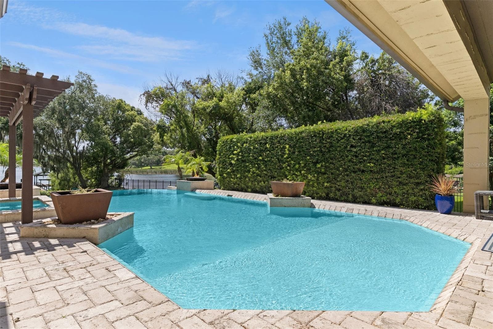 Large hedge provides privacy. Pool has baja shelf for that tanning in the water - 1629 HEMPEL AVE, WINDERMERE