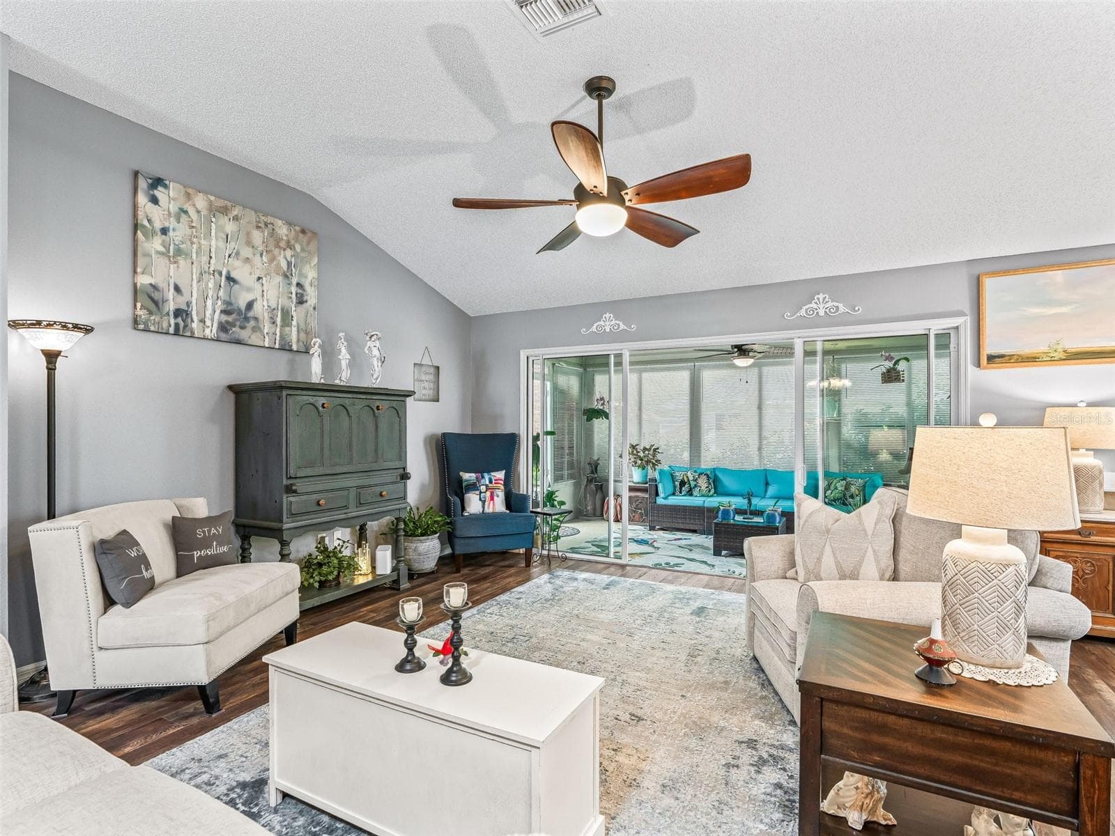 Generously sized gathering space features a vaulted ceiling, warm flooring, and a flexible layout for multiple seating arrangements. - 17946 SE 87TH MELROSE CT, THE VILLAGES