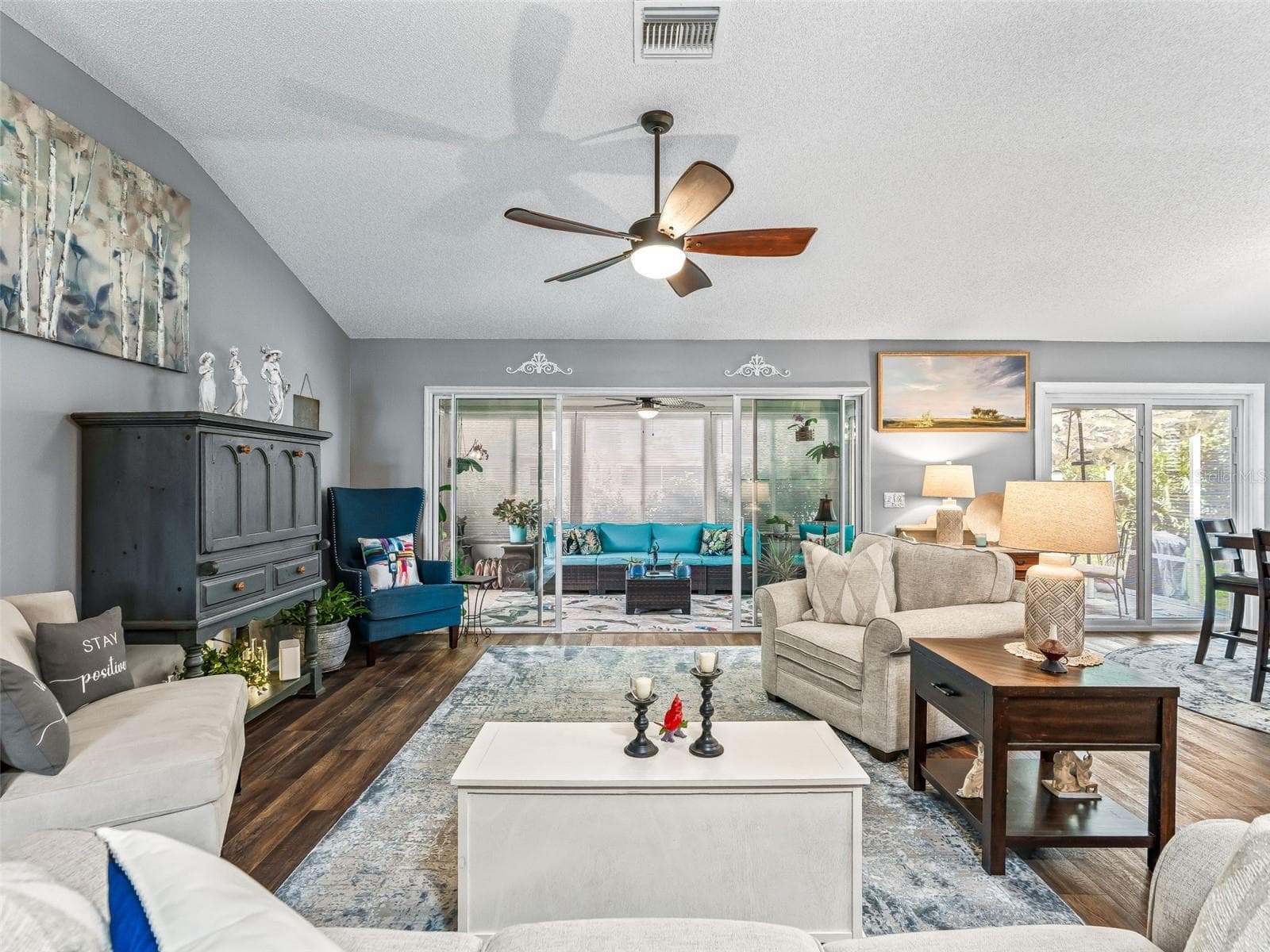 Large windows and sliding glass doors brighten the main living area while providing a pleasant view toward the enclosed rear living space. - 17946 SE 87TH MELROSE CT, THE VILLAGES