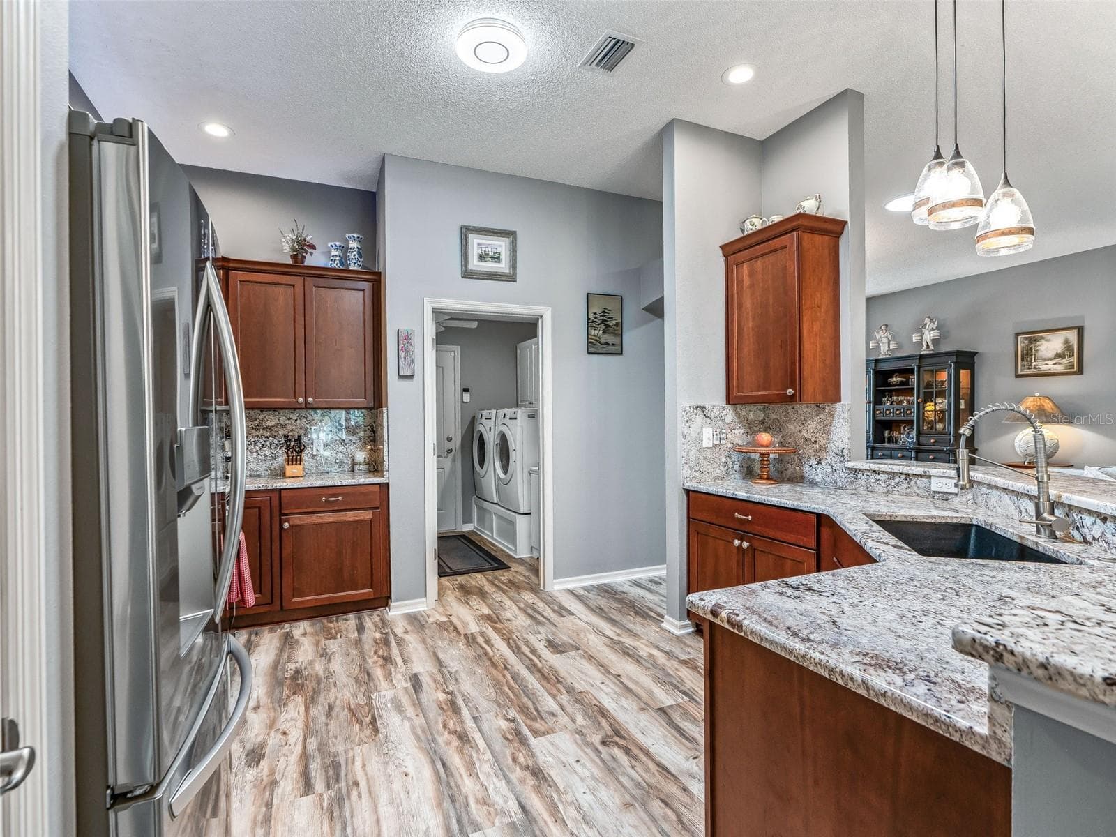 The kitchen offers generous counter space, abundant cabinetry, recessed lighting, and an efficient layout with convenient access to the adjoining utility area. - 17946 SE 87TH MELROSE CT, THE VILLAGES