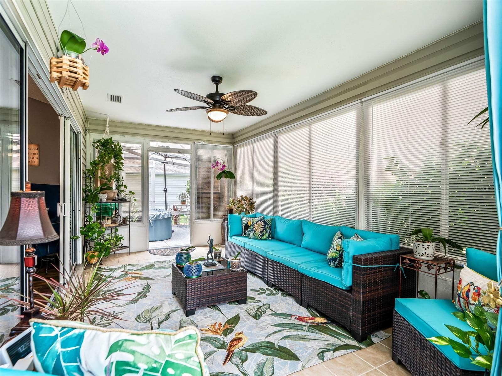 This inviting indoor-outdoor living space features abundant natural light, screened privacy panels, and a flexible layout for conversation, reading, or casual gatherings. - 17946 SE 87TH MELROSE CT, THE VILLAGES