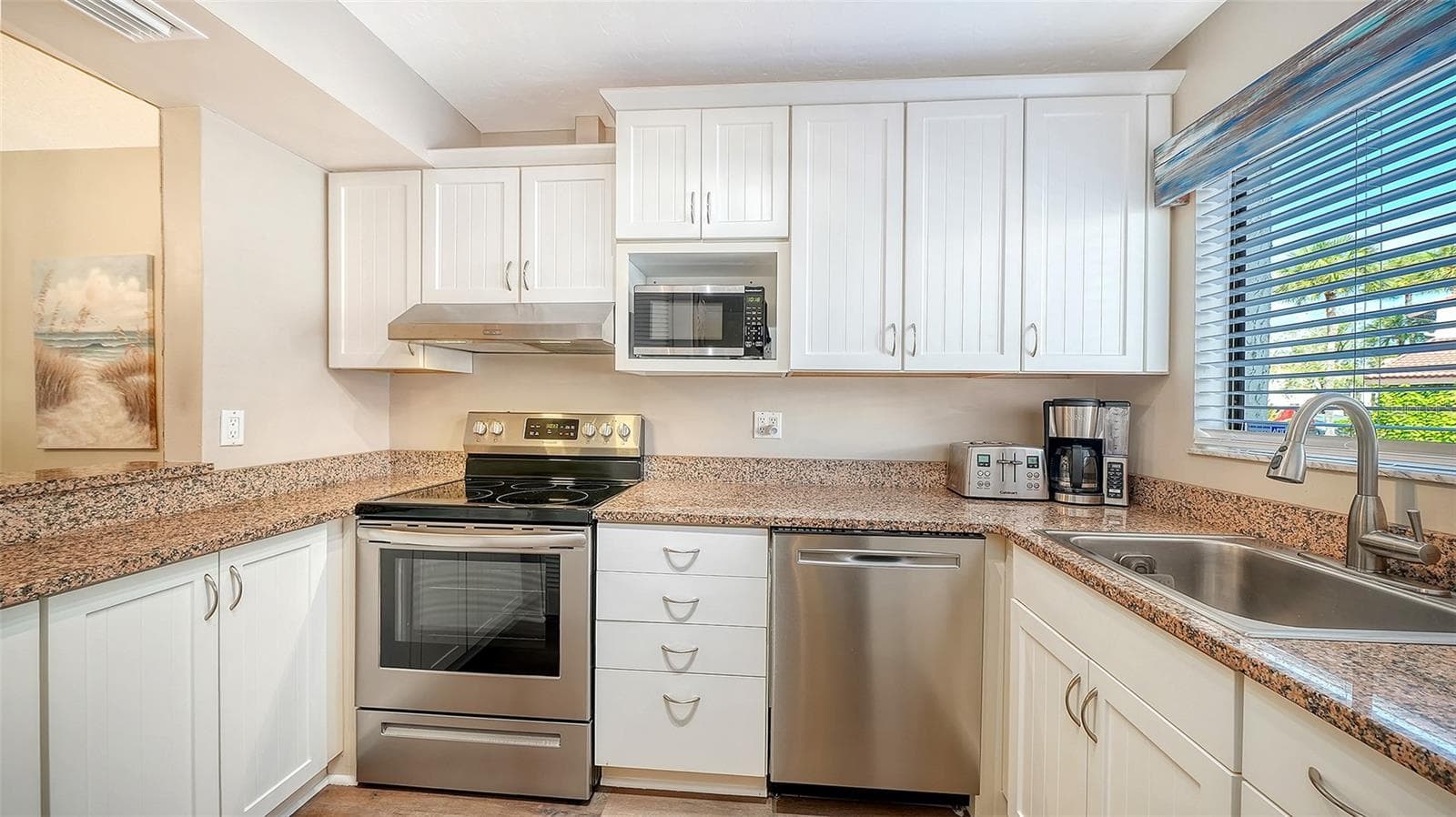 Kitchen with new stainless steel appliances. - 1646 STICKNEY POINT RD #101, SARASOTA