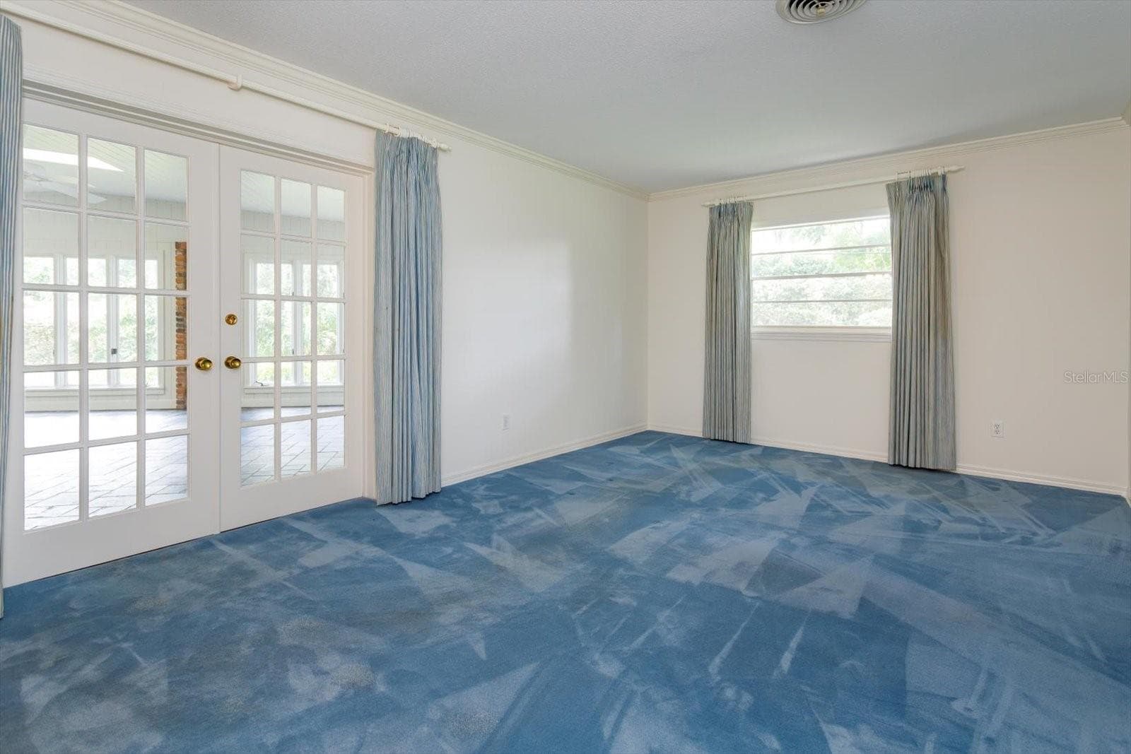 Primary Bedroom has french doors to Florida Room - 5019 GRAN LAC AVE, ORLANDO