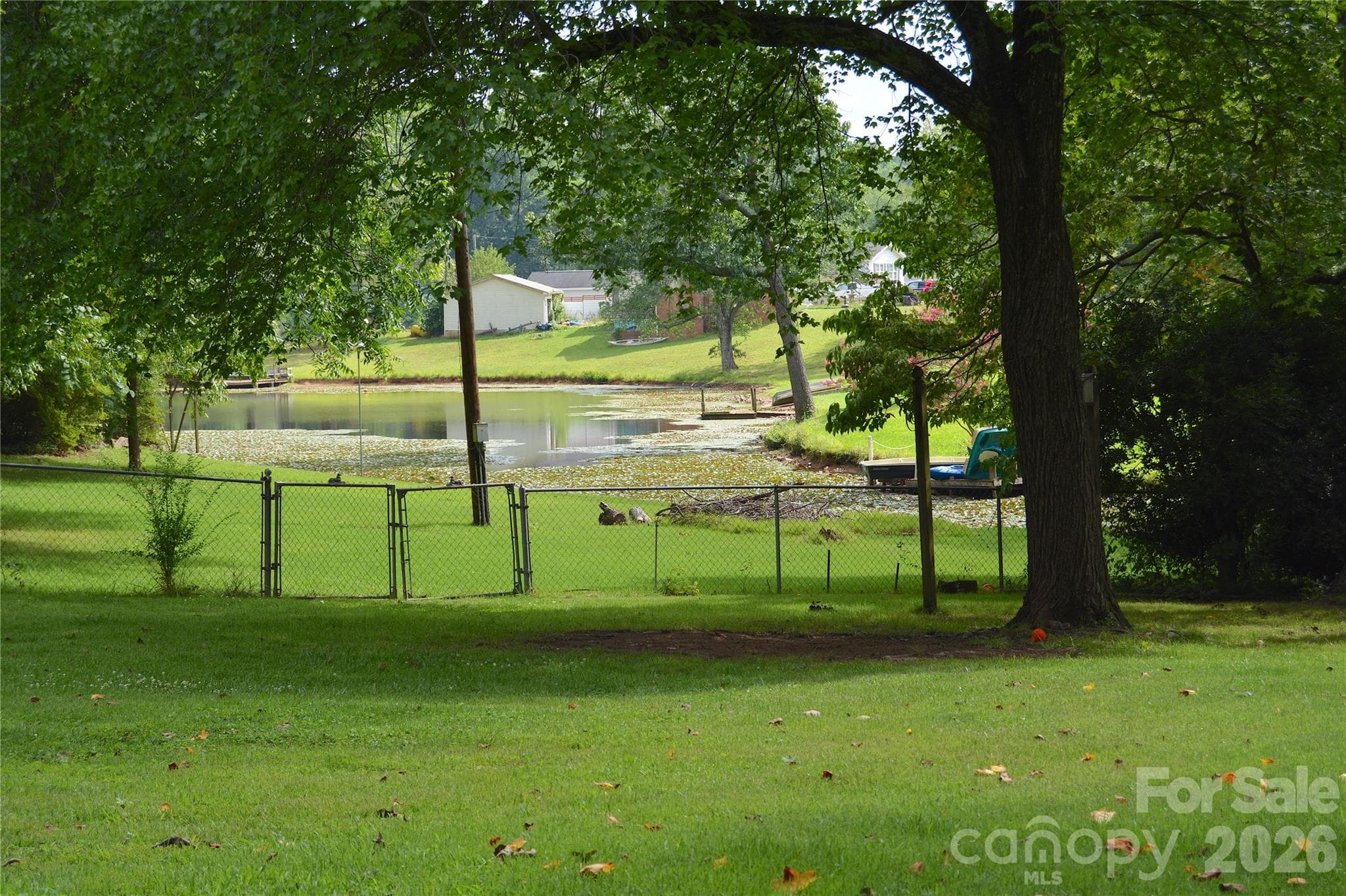 Backyard (fenced) view of lake - 467 Forest Lake Road, Forest City
