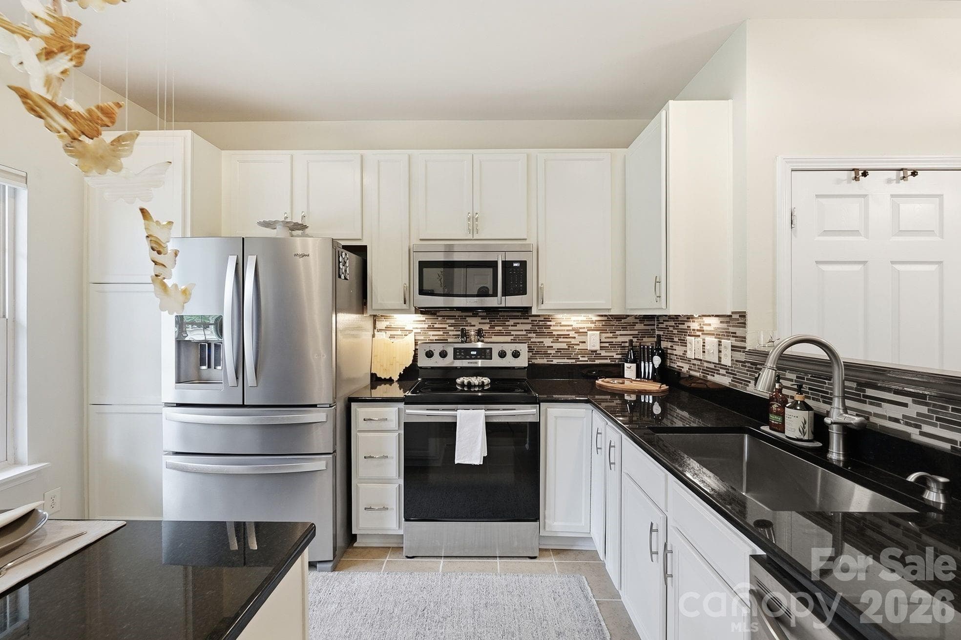 Kitchen with Stainless steel appliances & tile backsplash - 203 Tail Race Lane, Fort Mill