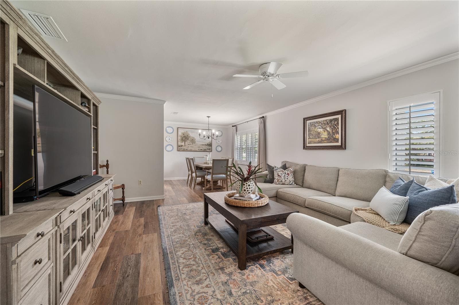 The formal living space flows seamlessly into the formal dining room perfect for entertaining. Plantation shutters adorn all of the windows in this home. - 1211 HUNT AVE, LAKELAND