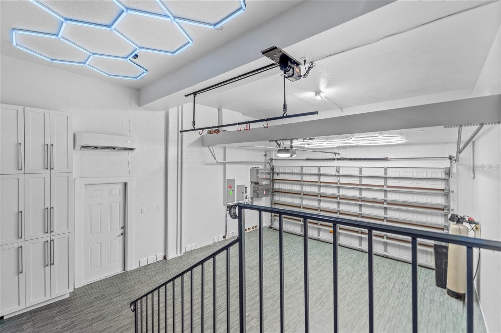 The two-car garage has been retrofitted as a home gym, with a ductless mini-split HVAC wall unit, upgraded lighting, and softer, cushioned flooring. - 4802 W BEACHWAY DR, TAMPA