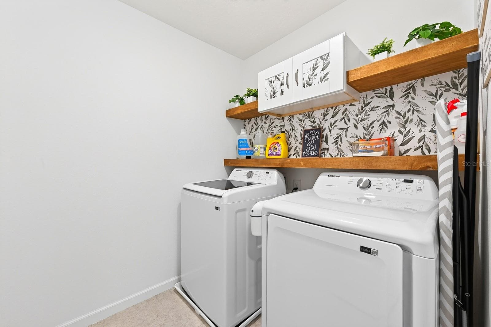 The upstairs Laundry Room includes the washer, dryer, and BUILT-IN SHELVING to keep everything organized. - 1961 HEMINGWAY CIR, GROVELAND