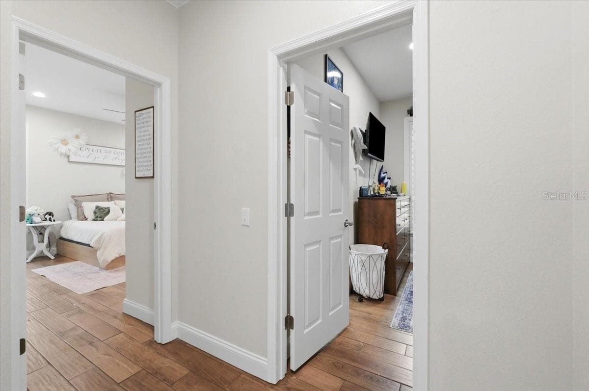 Hall leading to 2nd & 3rd bathrooms - 3158 BEAUCHAMP CT, WINTER HAVEN