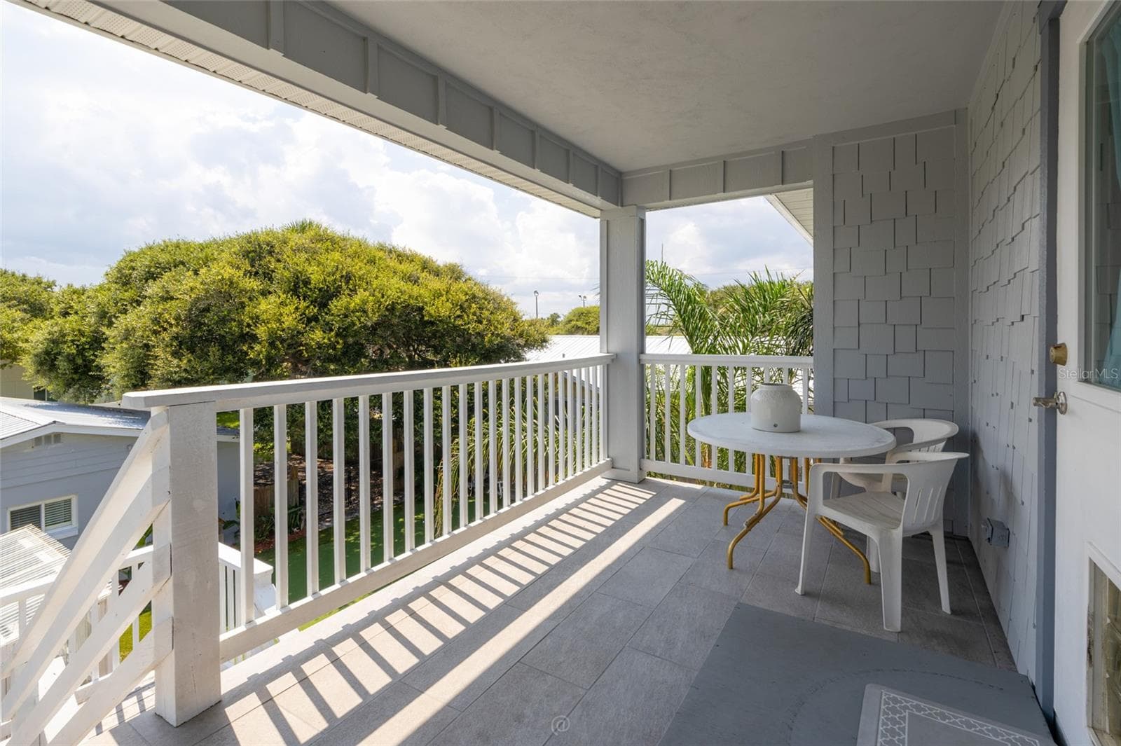 Rear porch/deck with tile facing West - 904 S DAYTONA AVE, FLAGLER BEACH