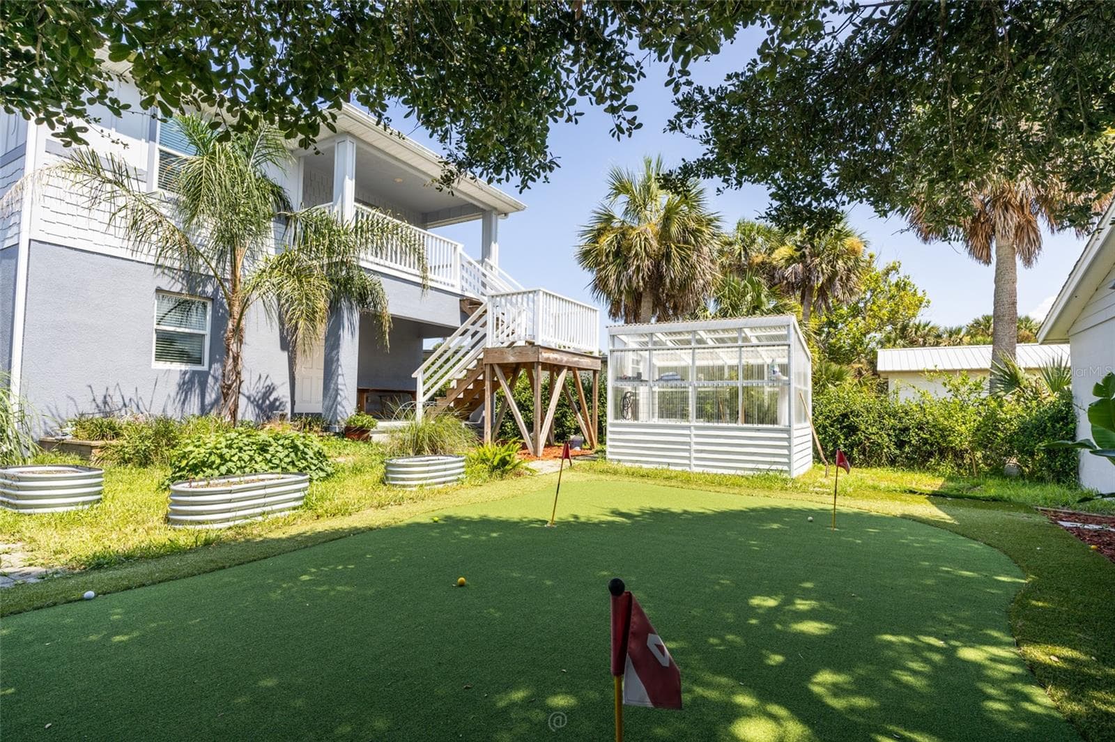 View of backyard & covered top & bottom porch - 904 S DAYTONA AVE, FLAGLER BEACH