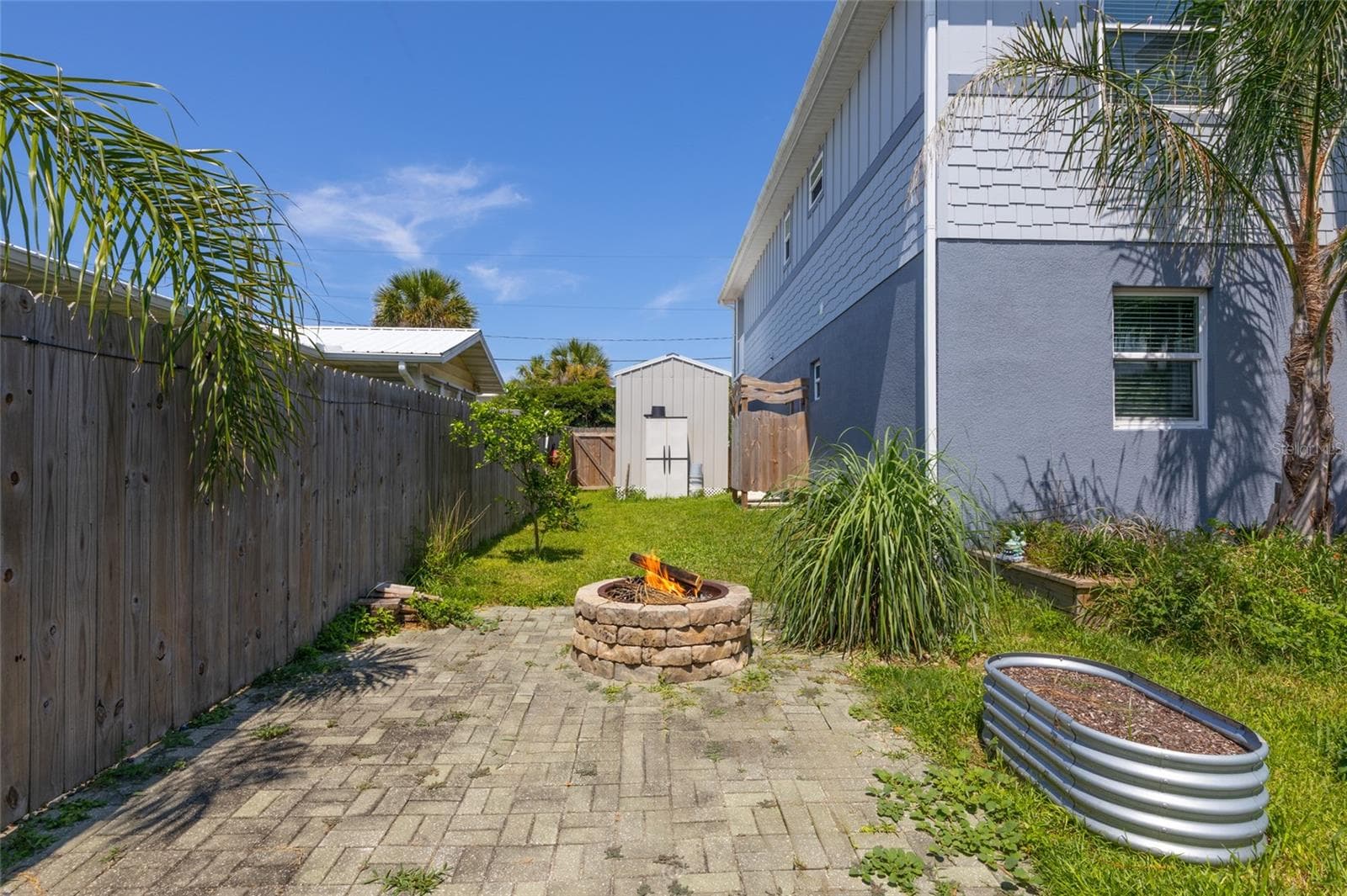 Firepit with brick pavers to enjoy the chilly winter evenings while taking in the salt air & breeze - 904 S DAYTONA AVE, FLAGLER BEACH