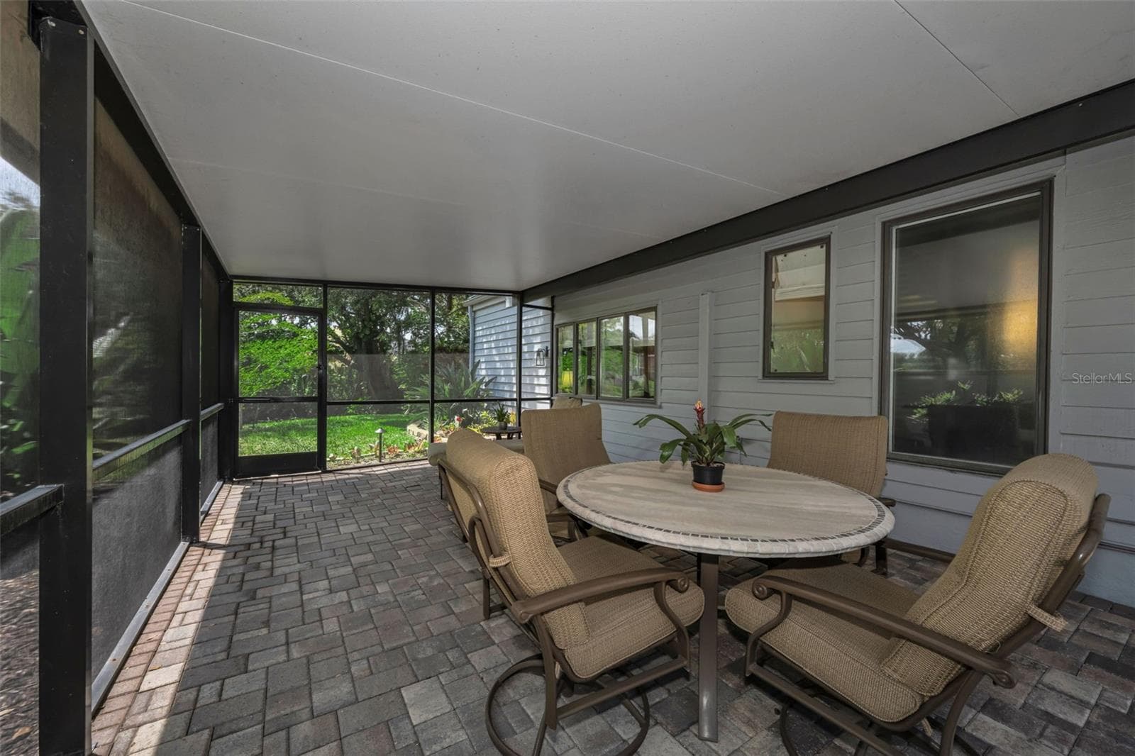 Screened side patio leading to the pond area. - 10497 LONGWOOD DR, SEMINOLE