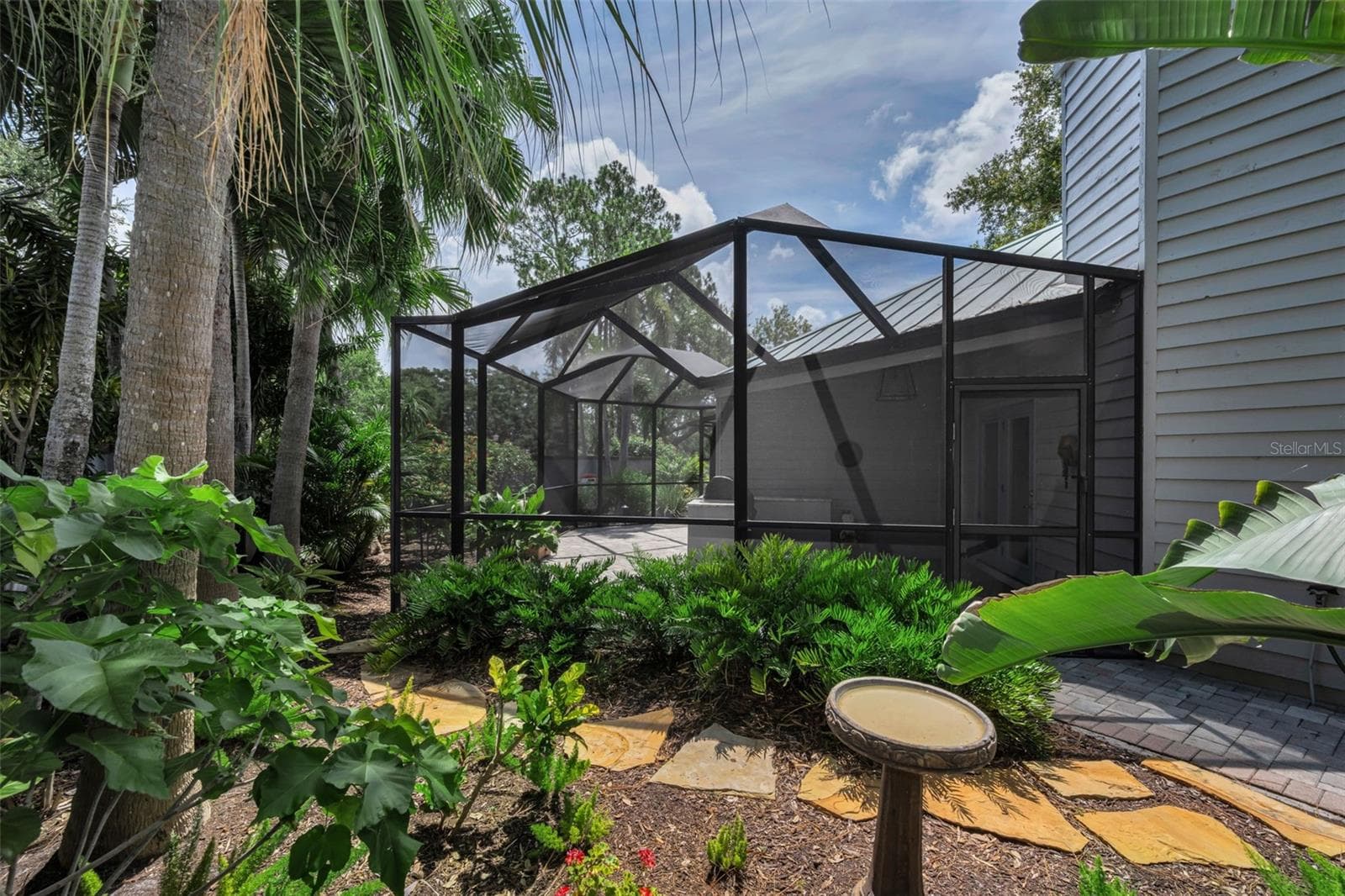 The screened patio area off the living room and wrapping around to the lovely pond. It has an outdoor grill and seating for many many guests! - 10497 LONGWOOD DR, SEMINOLE