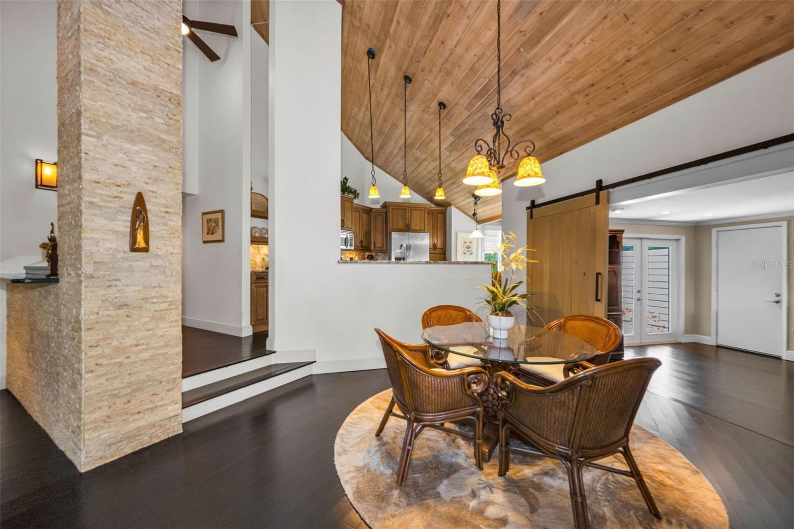 Lovely stacked stone details and the impressive vaulted tongue and groove ceiling are just stunning! - 10497 LONGWOOD DR, SEMINOLE