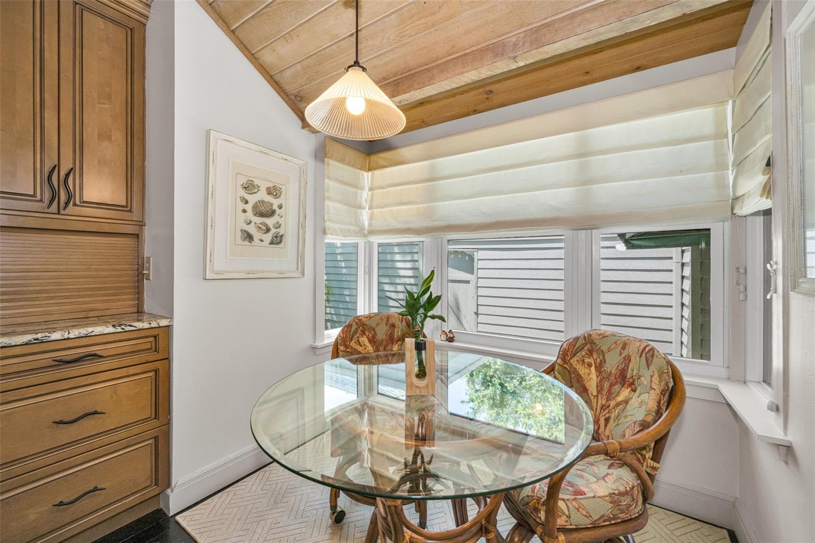 Breakfast nook and garden window with roman shades. - 10497 LONGWOOD DR, SEMINOLE