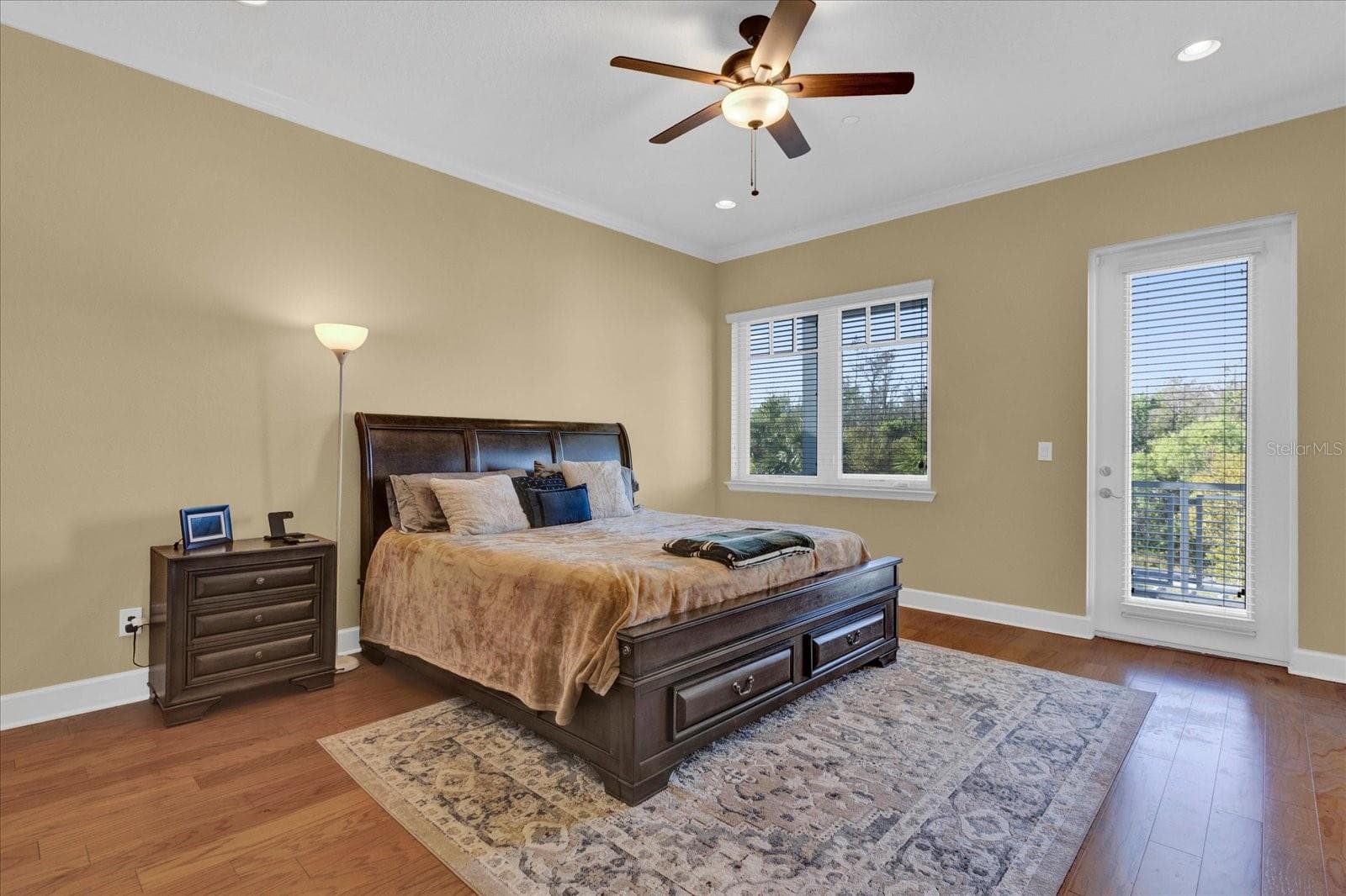Bright bedroom with ceiling fan and abundant natural light from dual windows. - 9219 LAUREATE BLVD, ORLANDO
