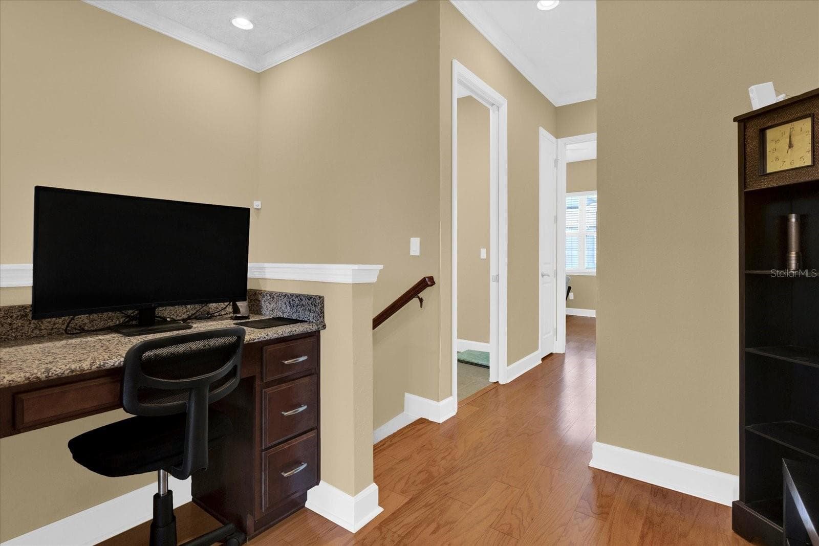Built-in workstation nook at the entrance to the primary suite — perfect for a compact home office or study spot. - 9219 LAUREATE BLVD, ORLANDO