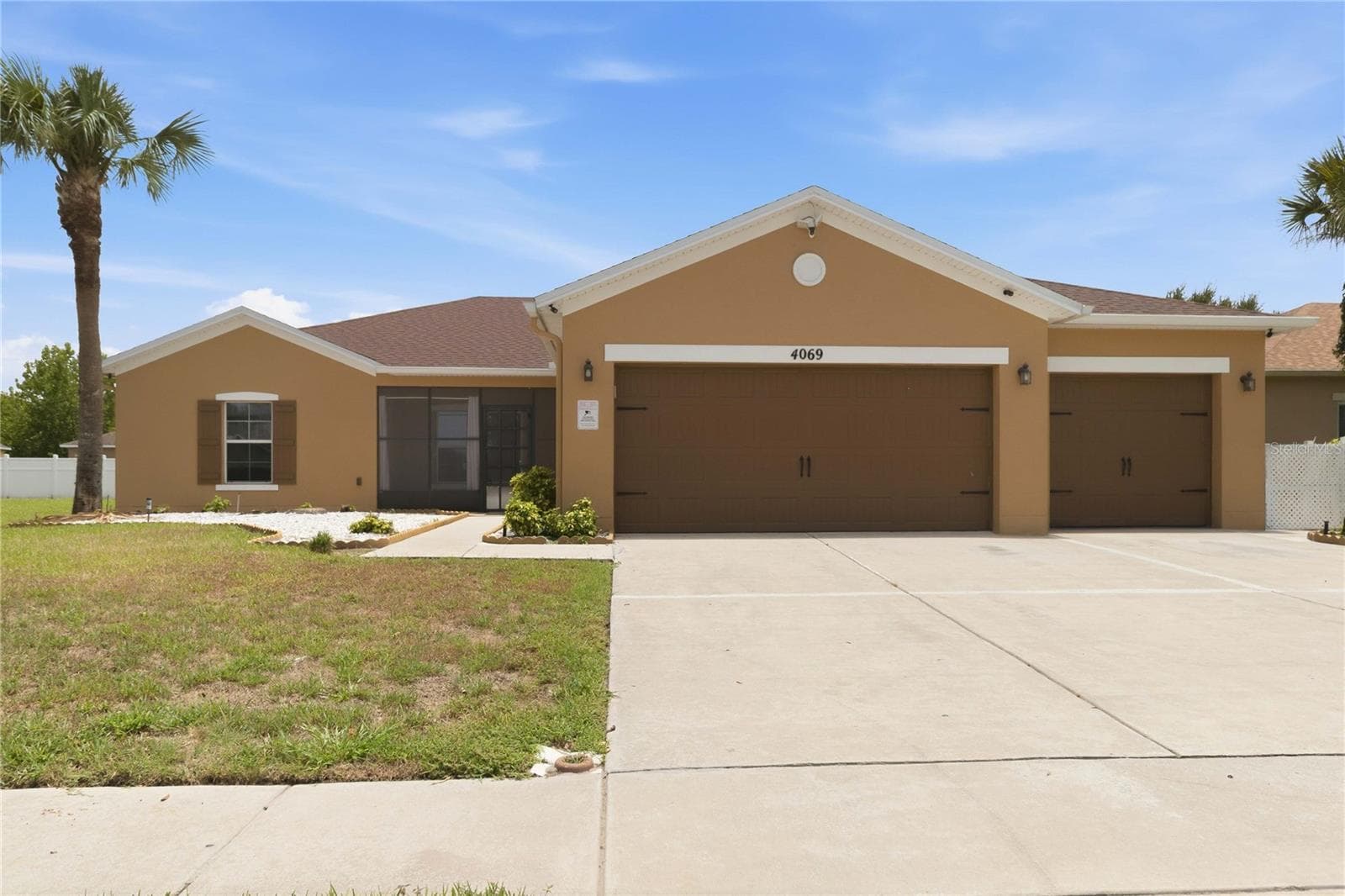 Exterior front, 3 car garage, fully fenced - 4069 MARINA ISLE DR, KISSIMMEE