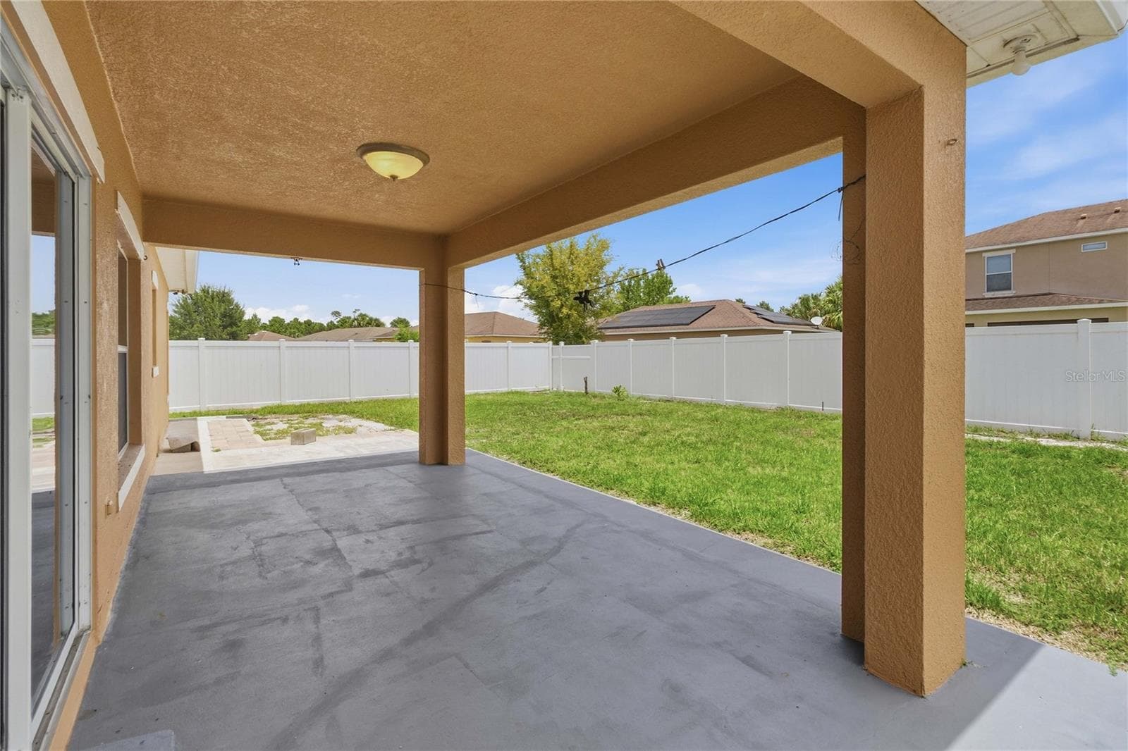 covered lanai from sliding door to back yard. Fully fenced in - 4069 MARINA ISLE DR, KISSIMMEE