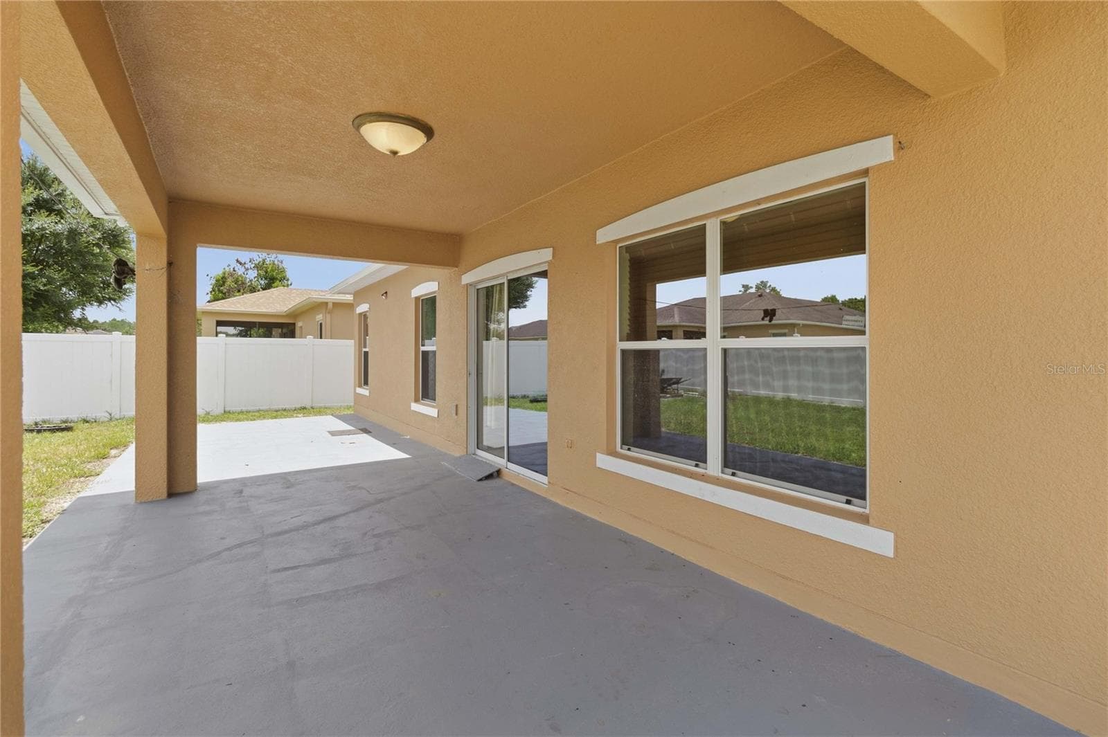covered lanai from sliding door to back yard. Fully fenced in - 4069 MARINA ISLE DR, KISSIMMEE