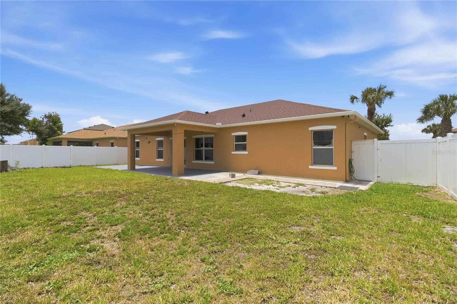 Rear exterior from backyard, covered lanai. fully fenced in - 4069 MARINA ISLE DR, KISSIMMEE