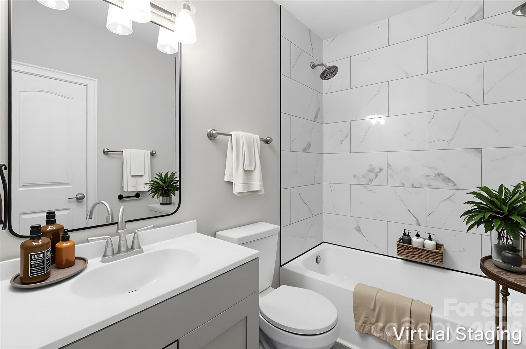 Walking into the full bath that is central to & easily accessible to all residents/guests of your home. Highlights include new vanity (cabinetry, sink, mirror & light fixture) & tile surround on the wall for the tub/shower combo (virtually staged & enhanced). - Charlotte