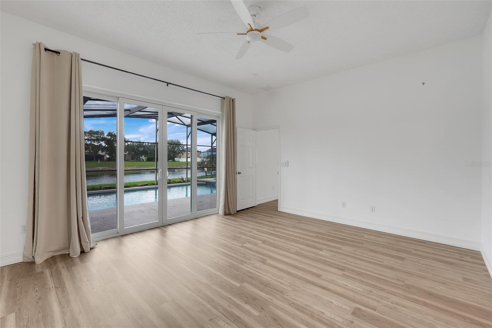 Downstairs master suite with sliding glass doors leading to pool/spa - 16740 GLENBROOK BLVD, CLERMONT