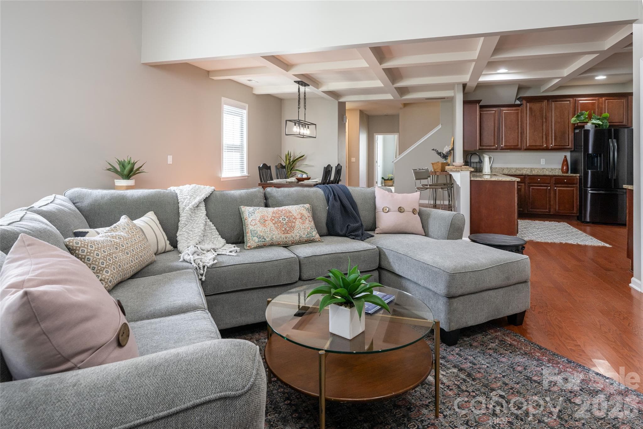 Light-filled living room with gas fireplace and open flow to the kitchen. - Weaverville