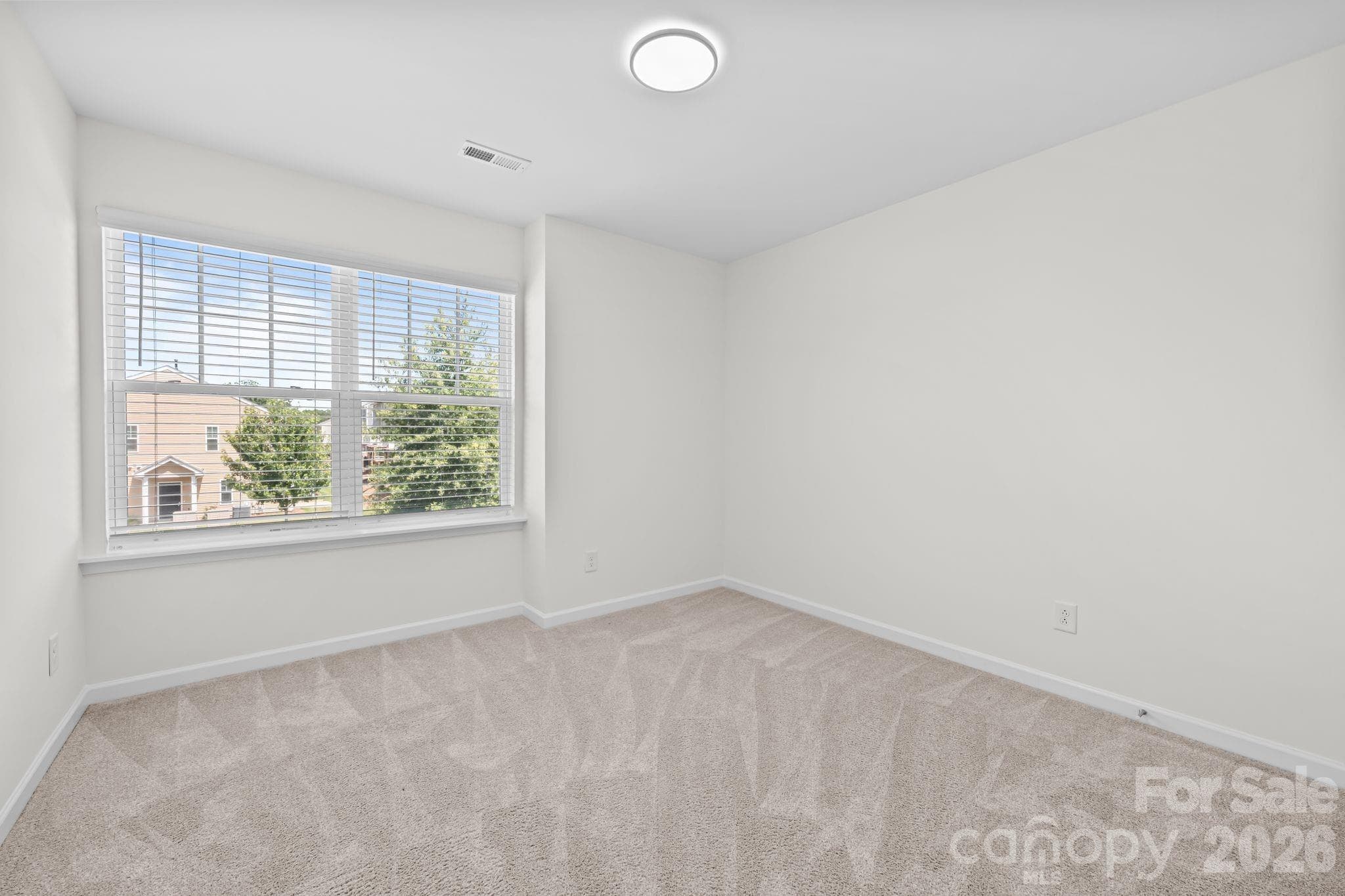 Secondary bedroom with walk in closet. - 5516 John Mcdowell Place, Charlotte