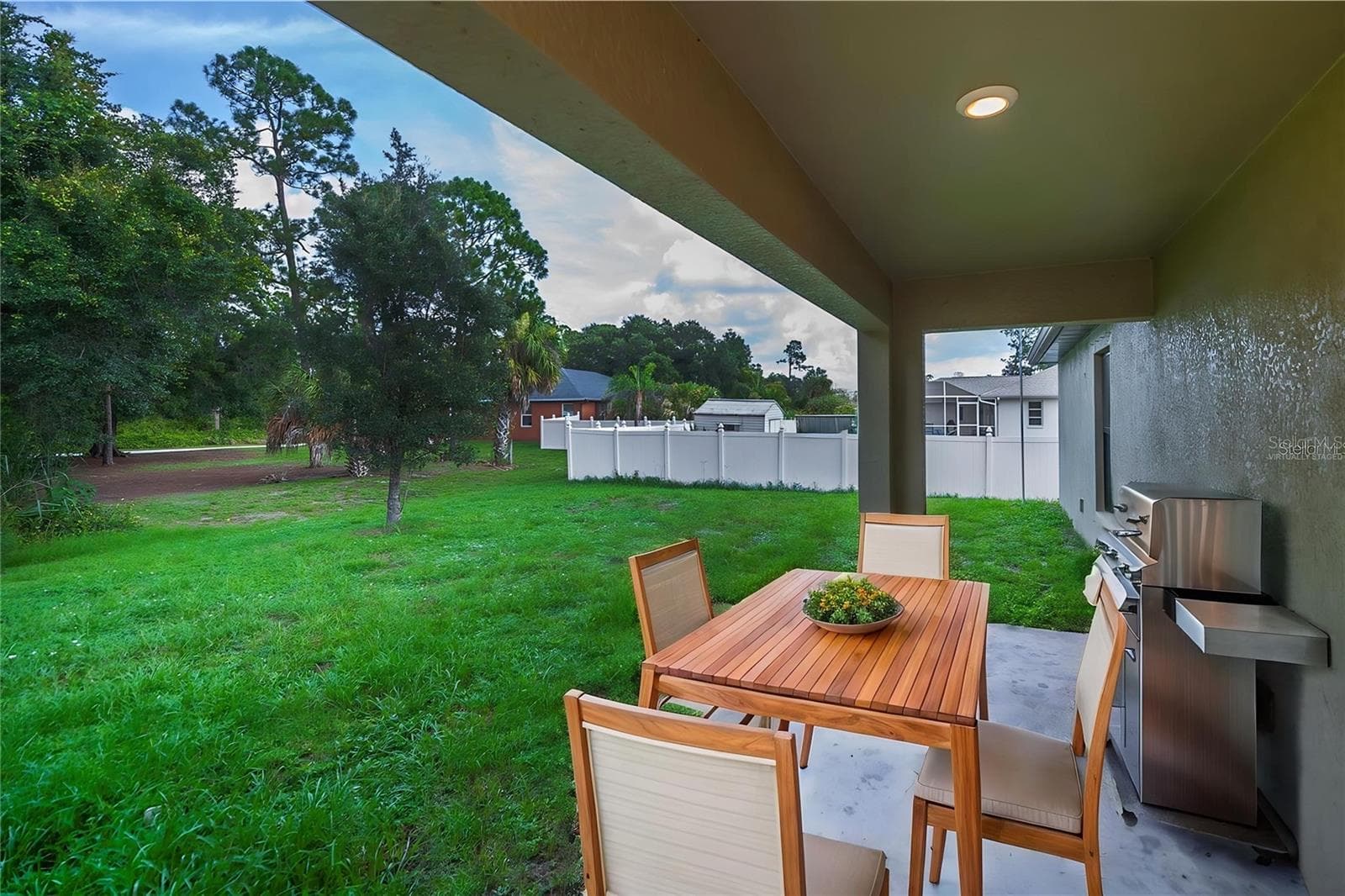 Large Backyard with Covered Patio Virtually Staged - 2555 ATWATER DR, NORTH PORT