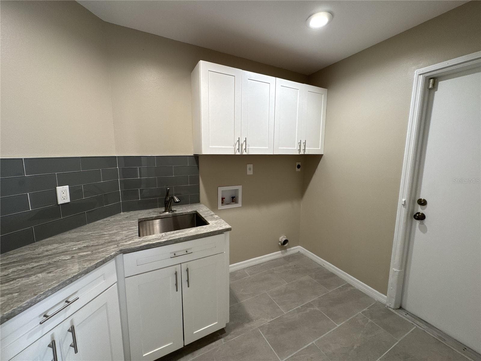 laundry room with exit to garage - 3174 57TH AVENUE CIR E, BRADENTON
