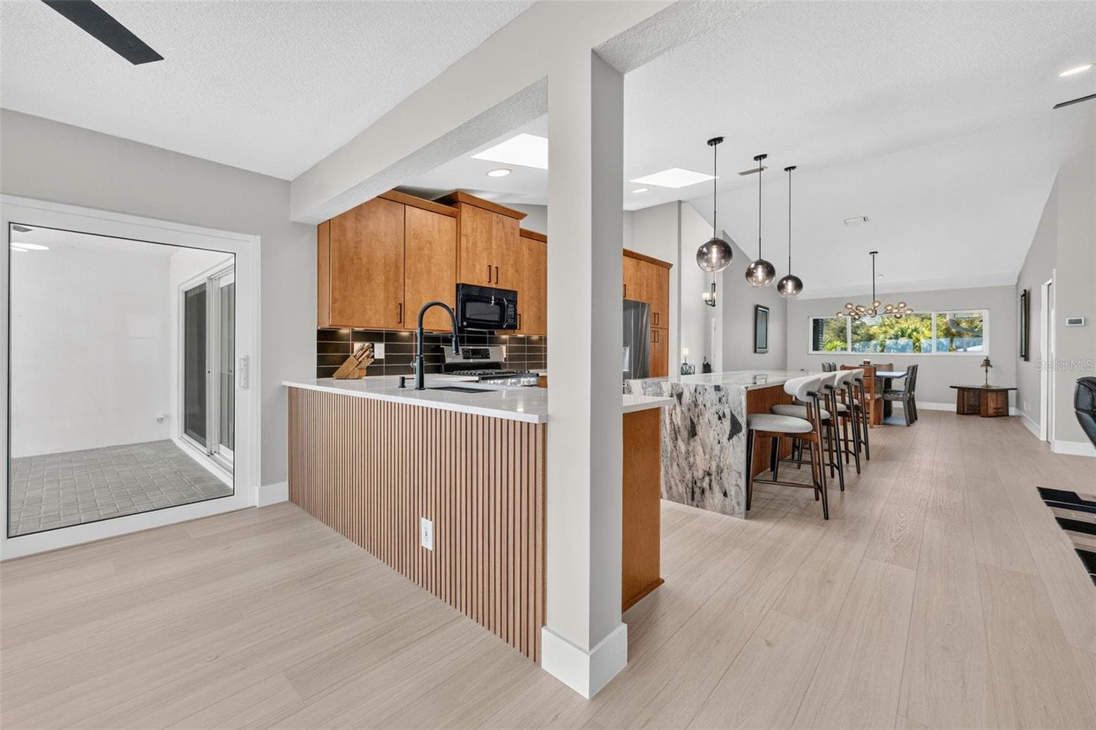 A beautifully remodeled kitchen featuring premium finishes, timeless design, and a warm, welcoming atmosphere you'll love coming home to. - 2936 68TH AVE S, ST PETERSBURG