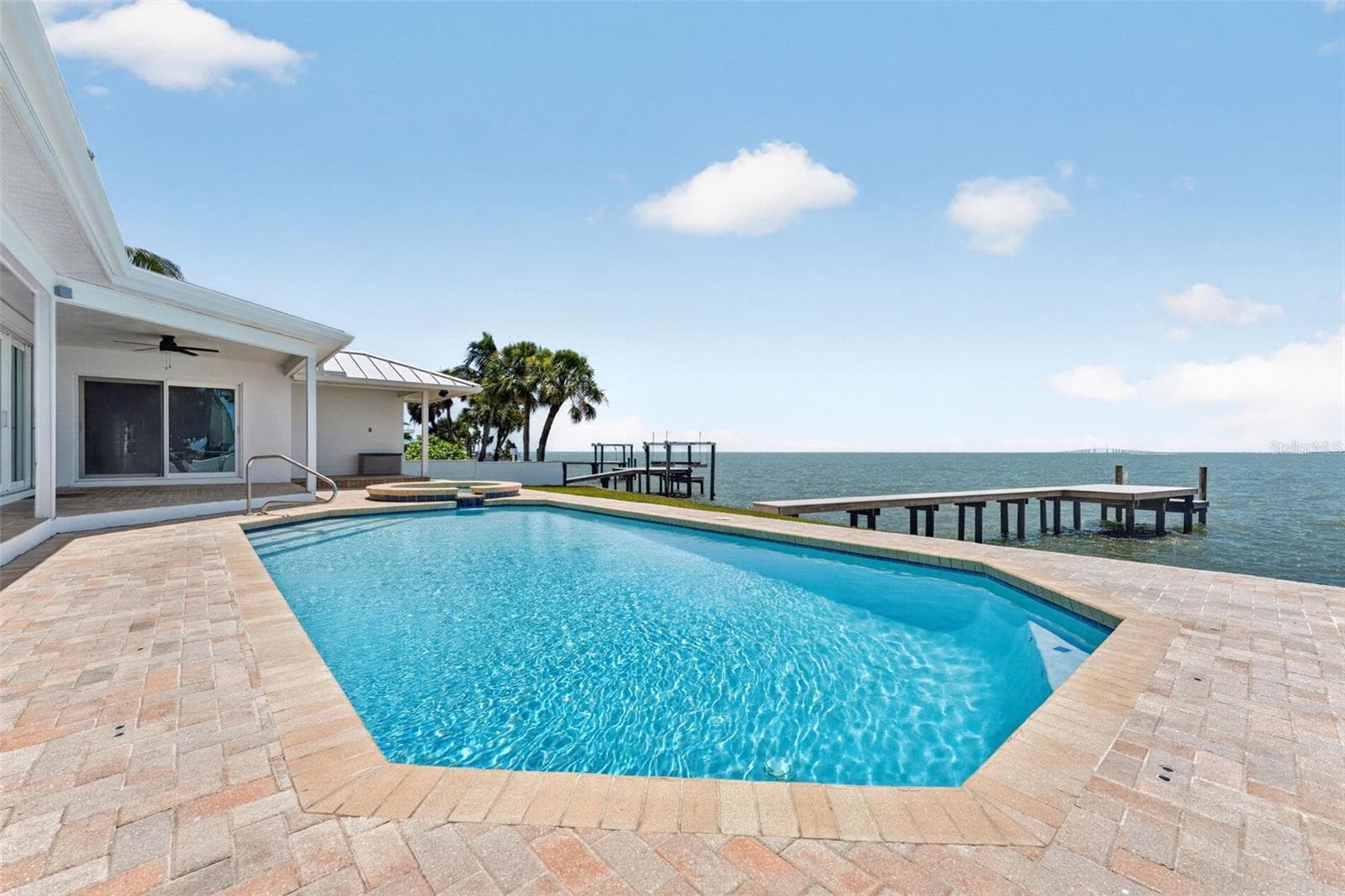 Stunning outdoor oasis featuring covered patios, a sparkling pool, and a relaxing spa—perfect for entertaining or unwinding. - 2936 68TH AVE S, ST PETERSBURG