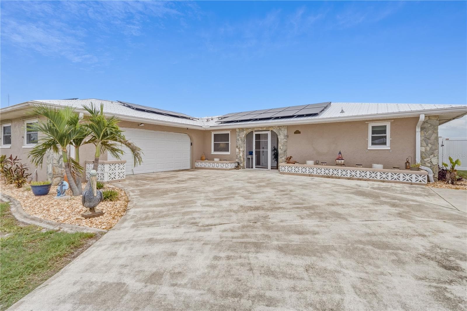 Welcoming Front Exterior with Metal Roof and Paver Driveway - 2284 BROAD RANCH DR, PORT CHARLOTTE