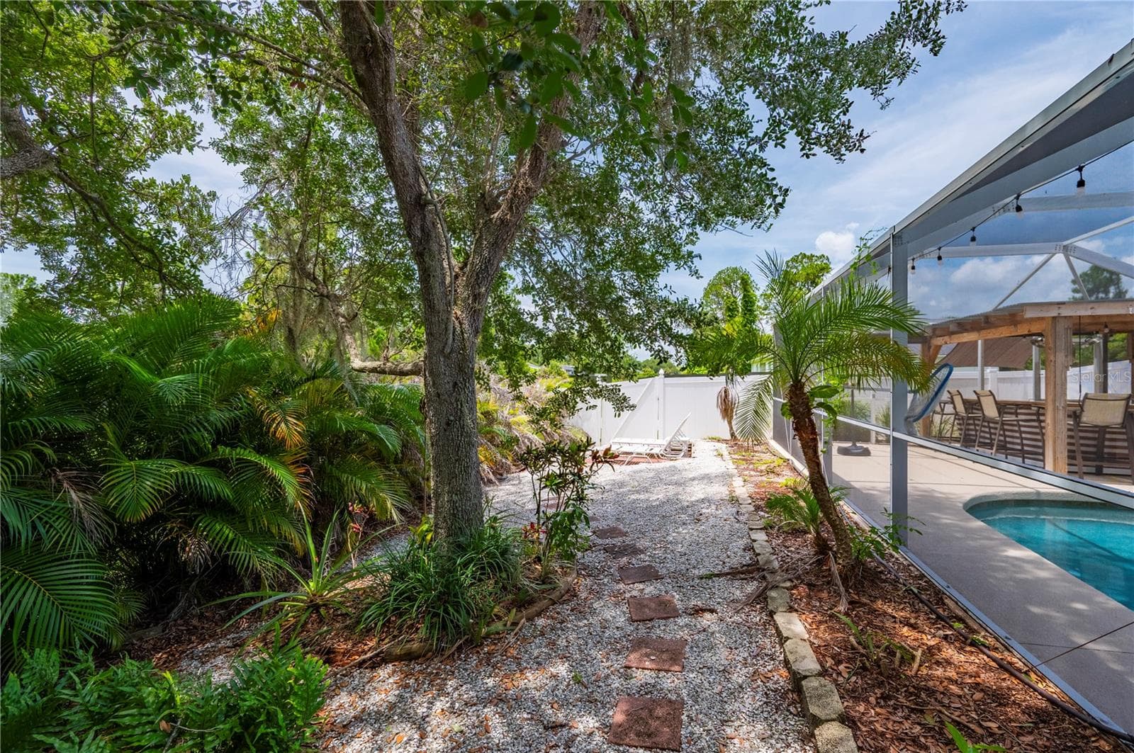 Backyard features pool, summer kitchen, privacy and shady fire pit area. - 5615 MOJAVE AVE, NORTH PORT