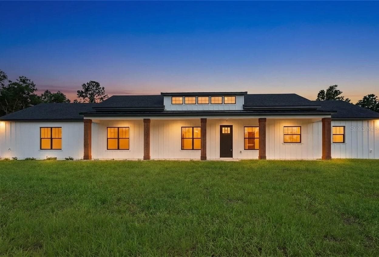 AI enhanced image with lights in windows - 8730 NW 17TH CIR, OCALA