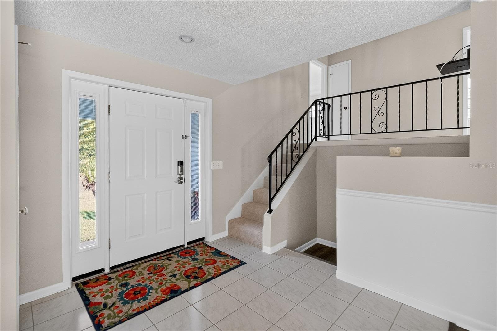 Front Door entry to foyer - main floor with eat-in kitchen, liivng room, dining room. Bright and light. Upstairs to 4 bedrooms. Downstairs to workshop garage, 1/2 bath, laundry room and 5th Bedroom OR Bonus Room or potential Mother-in-Law suite. - 656 LITTLE WEKIVA RD, ALTAMONTE SPRINGS
