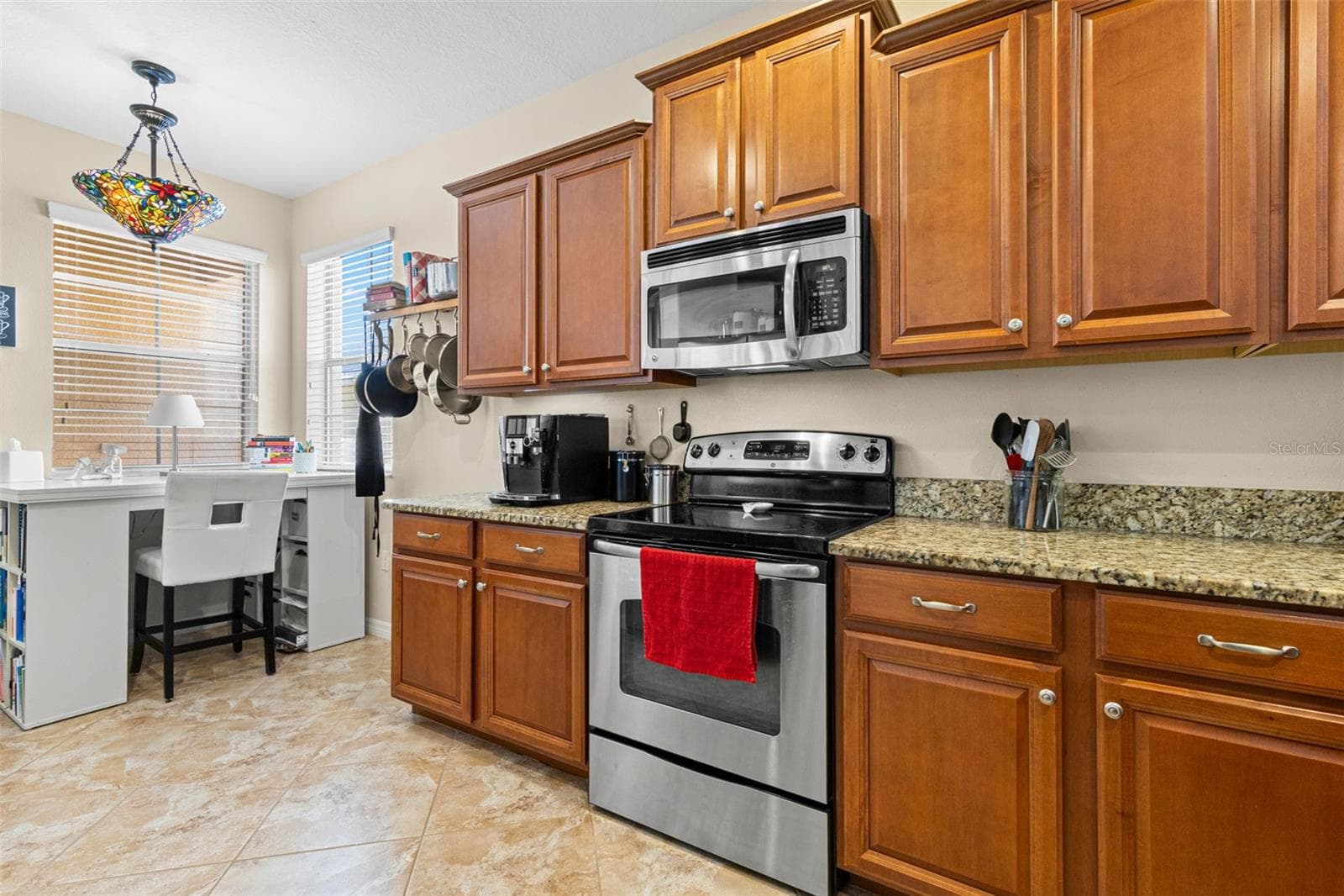 A windowed corner brings natural light into the kitchen and creates an easy spot for a small desk, coffee station or casual seating. - 9524 TRUMPET VINE LOOP, NEW PORT RICHEY