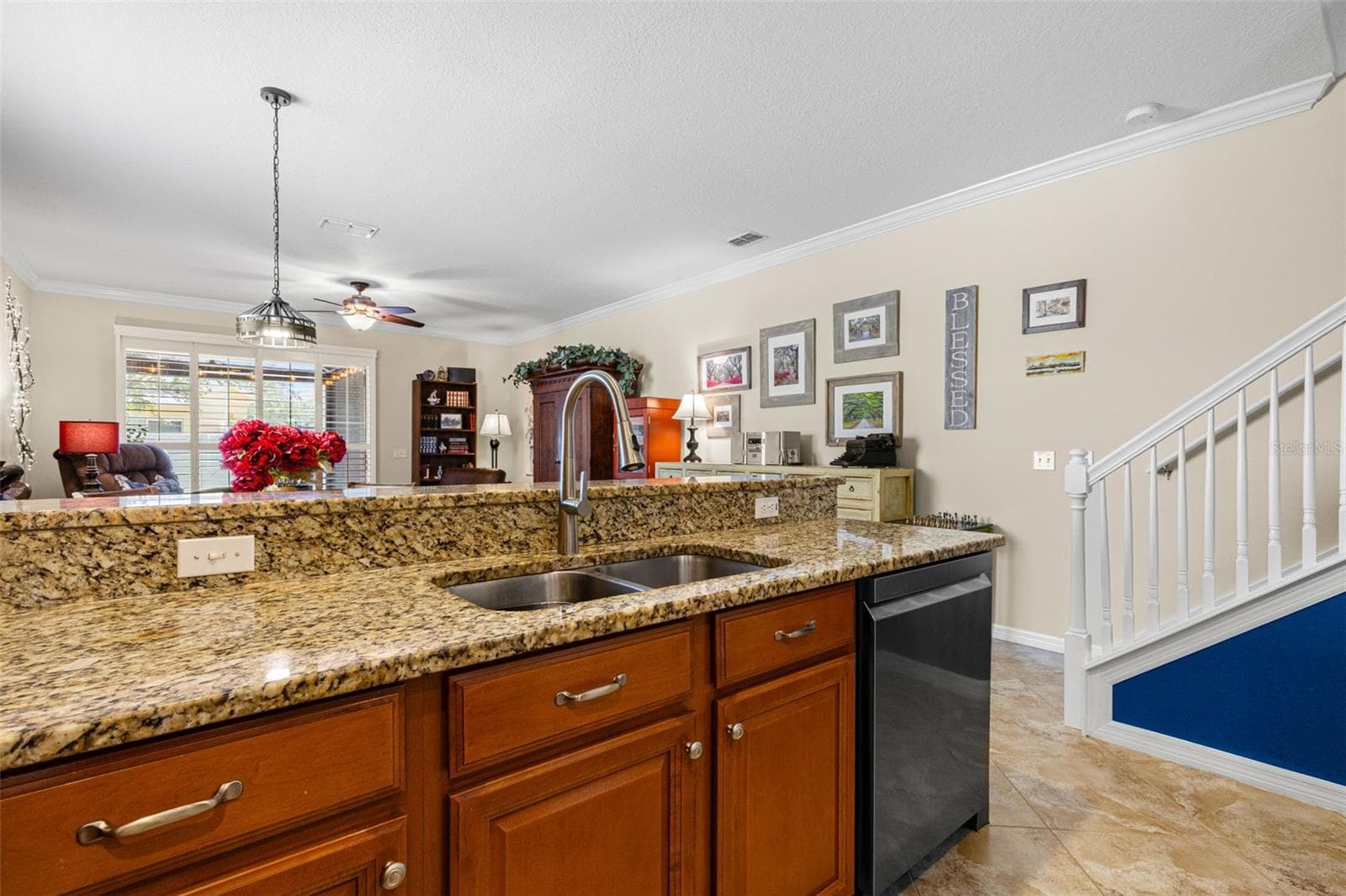 The raised breakfast bar creates a natural spot for casual meals and serving, while the double-basin sink overlooks the living area. - 9524 TRUMPET VINE LOOP, NEW PORT RICHEY