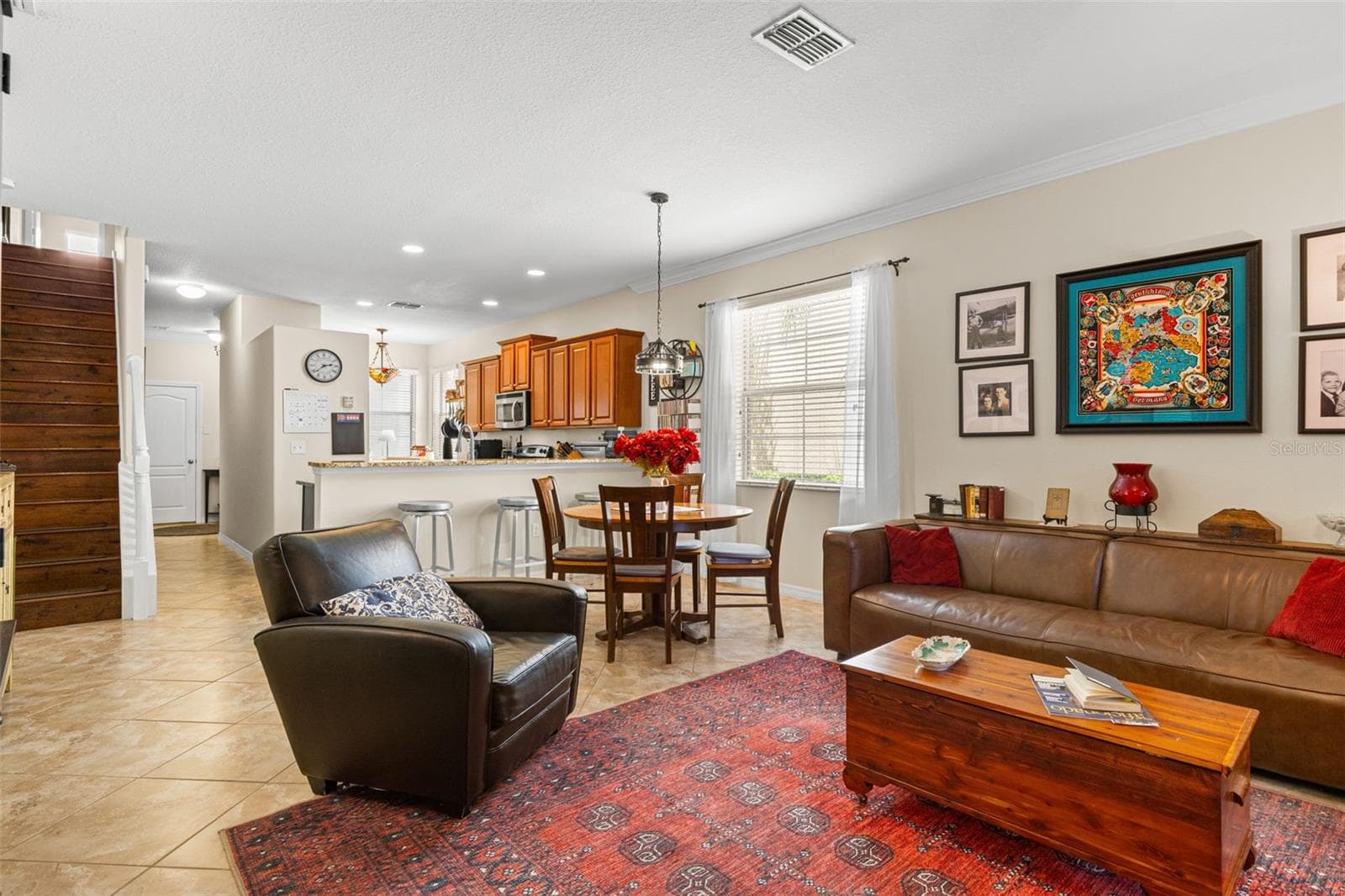 From the living room, the first floor feels open and connected, with the dining area, breakfast bar and kitchen all within easy reach. - 9524 TRUMPET VINE LOOP, NEW PORT RICHEY