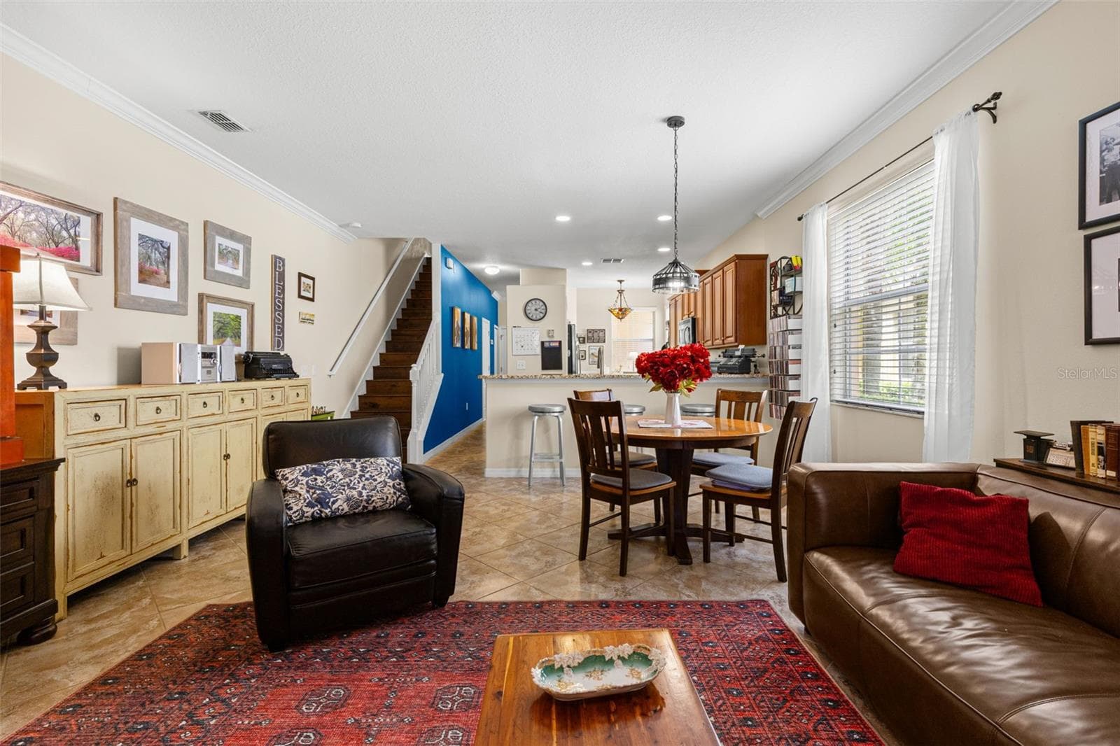 A large window brightens the dining area, which feels clearly defined while remaining open to both the living room and kitchen. - 9524 TRUMPET VINE LOOP, NEW PORT RICHEY