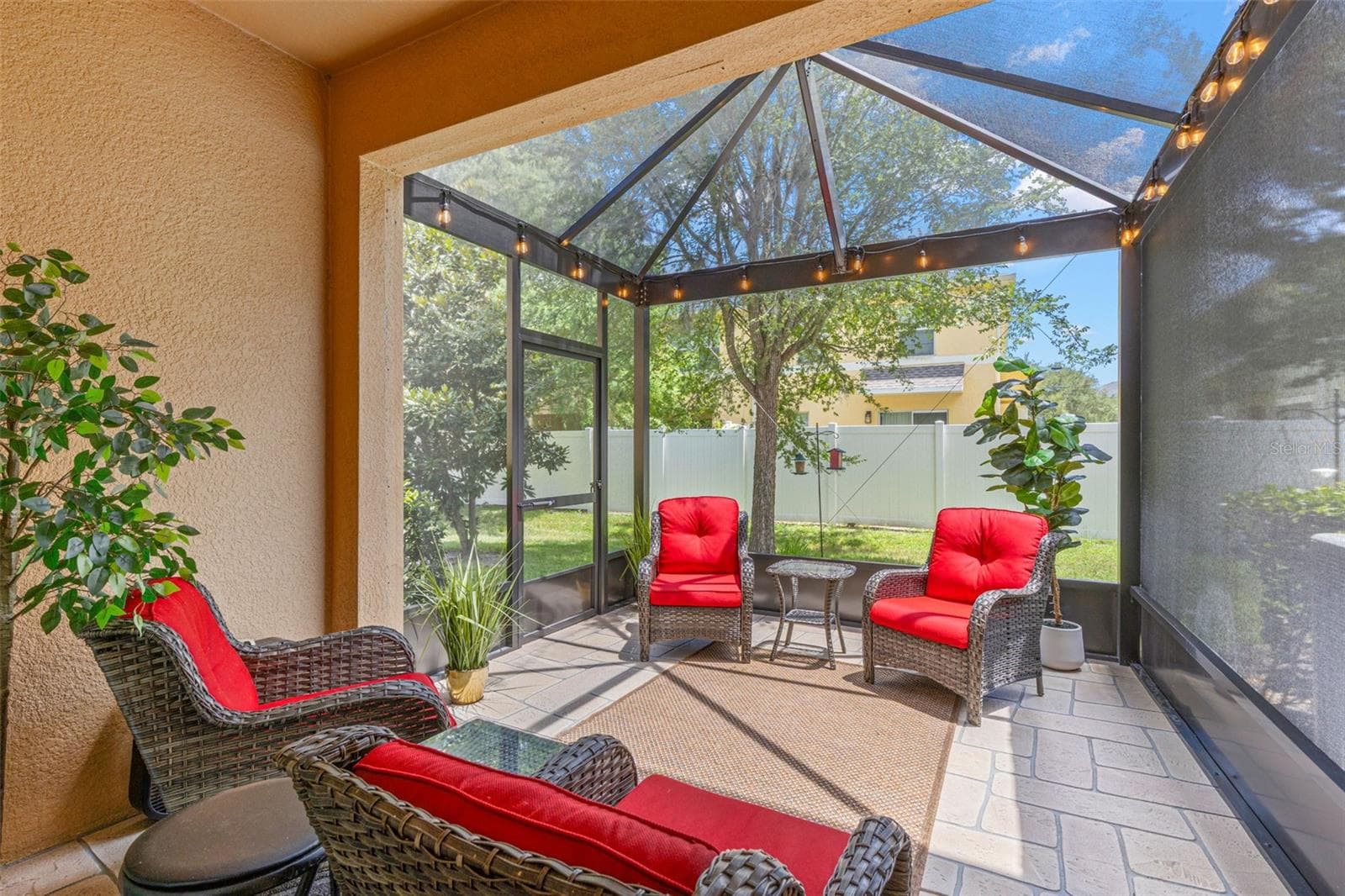 The 13-by-9 screened lanai, added in 2026, features stamped-concrete flooring and 80/90 screening overhead, with plenty of room for comfortable outdoor seating. - 9524 TRUMPET VINE LOOP, NEW PORT RICHEY