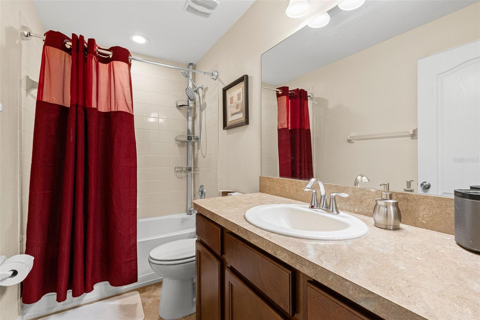 Bathroom 3 includes a tub-and-shower combination, a single vanity with generous counter space and a large wall mirror. - 9524 TRUMPET VINE LOOP, NEW PORT RICHEY