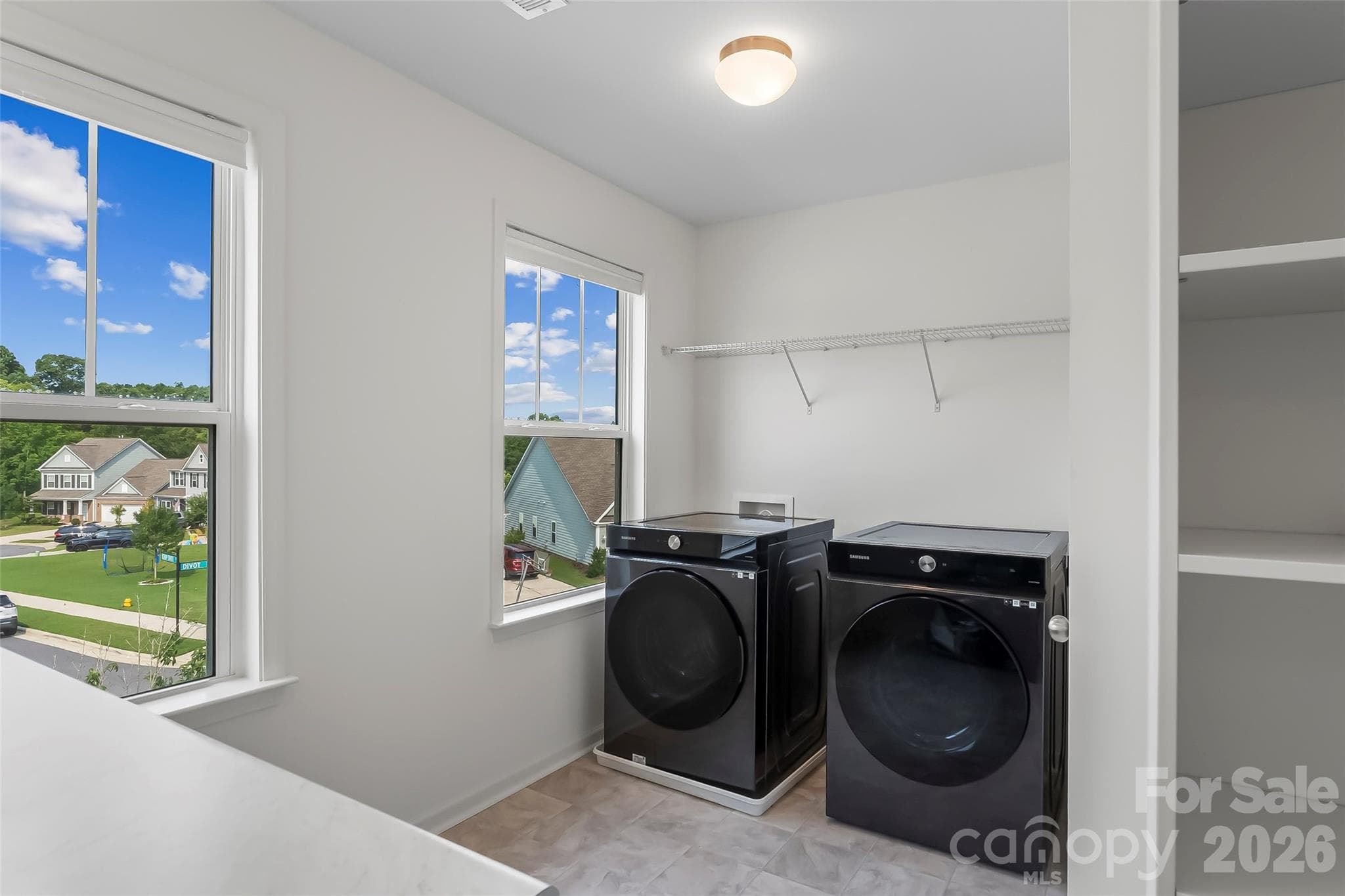 Large Laundry room built in shelving with folding table. Smart Samsung front load washer/ dryer - 112 Divot Lane, Statesville
