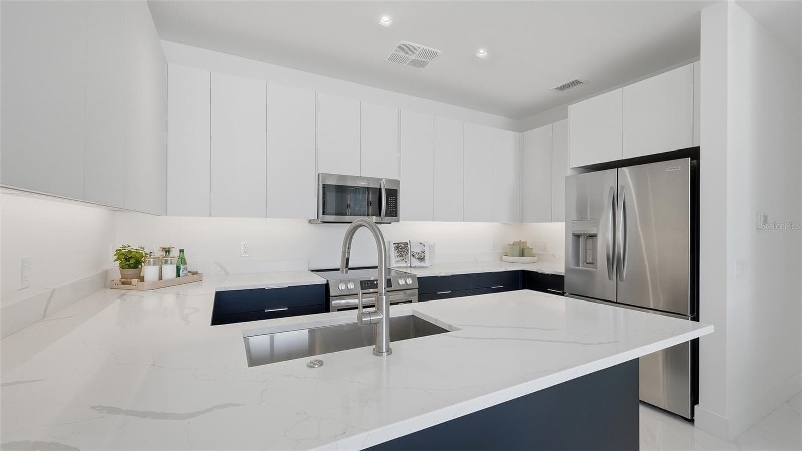This designer kitchen is ready for your special chef's cuisine with its European cabinetry, stainless appliances and luxurious quartz countertops. - 430 KUMQUAT CT #202, SARASOTA
