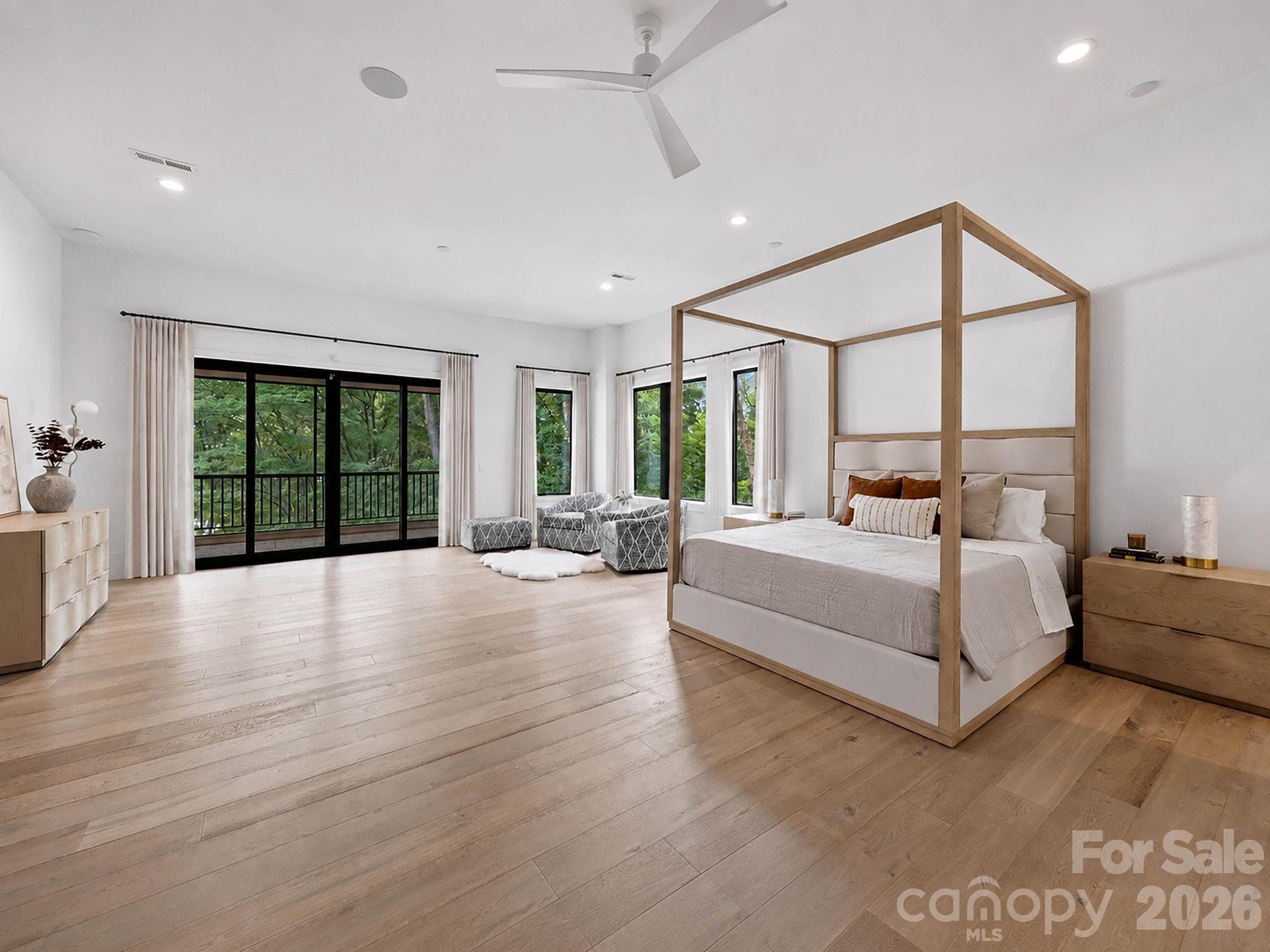 Primary suite speaks for itself- linear fireplace and a private balcony - 13702 Sage Thrasher Lane, Charlotte